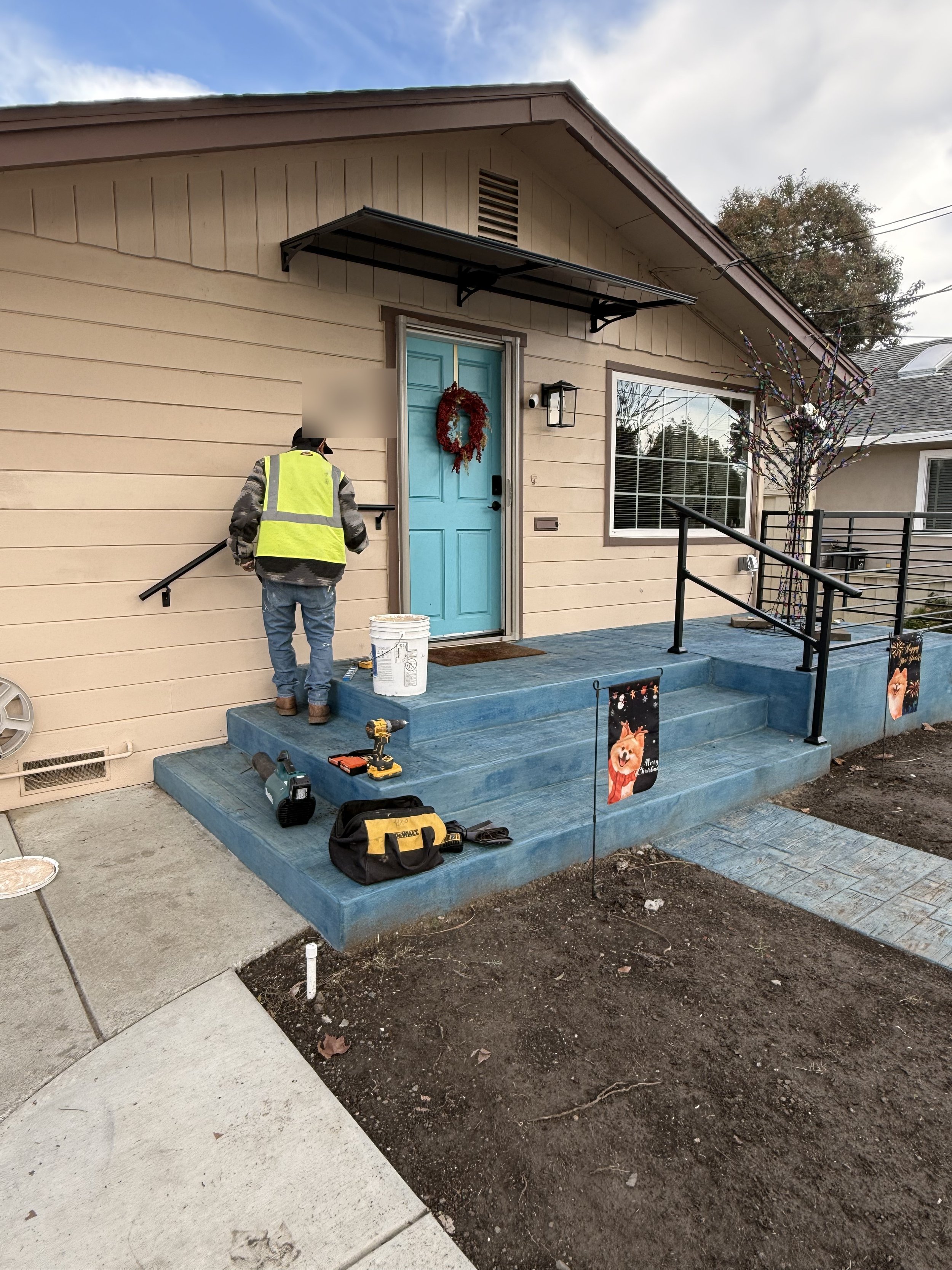 Finished front porch stairs with stained railings in San Jose