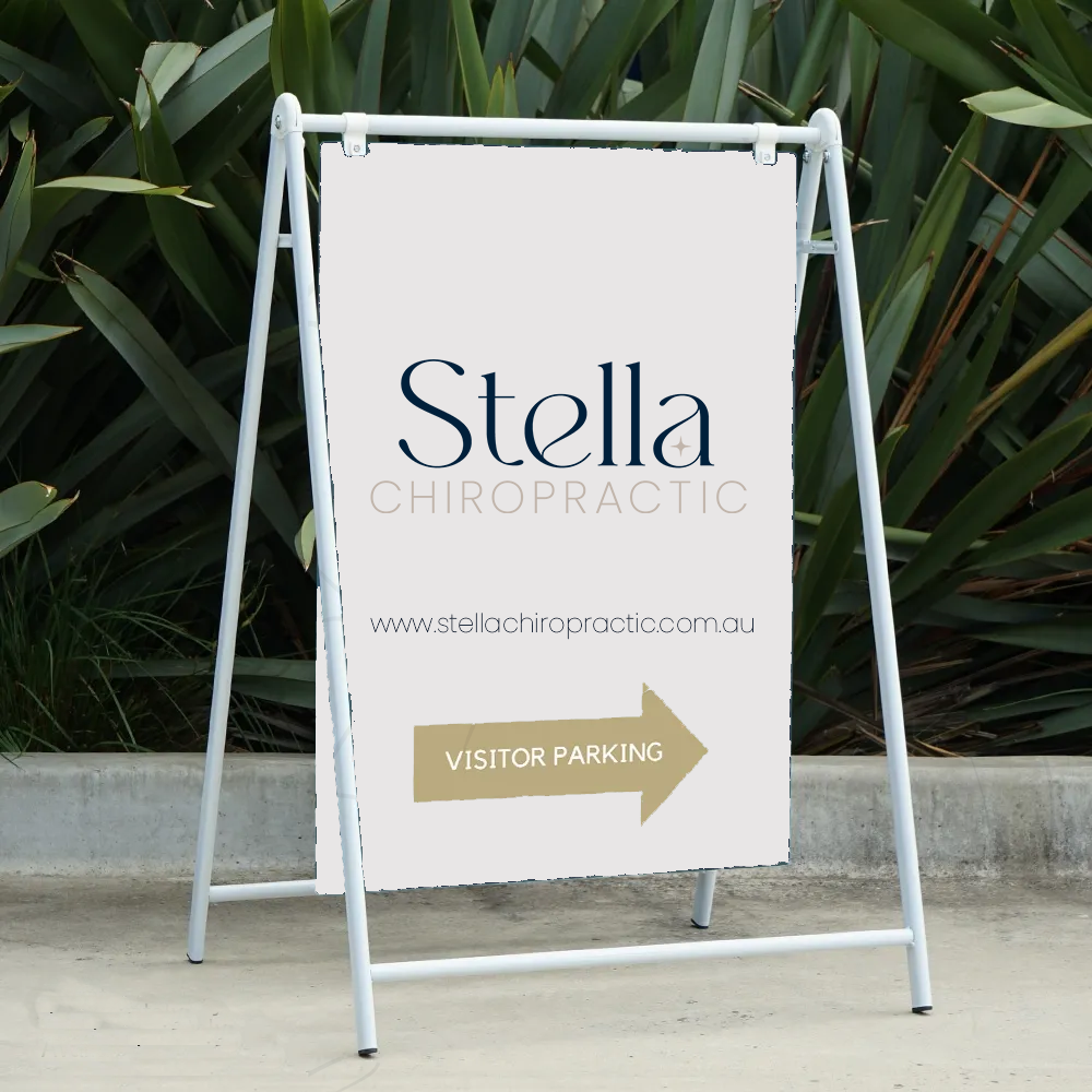 A-frame signboard with 'Stella Chiropractic' logo, website link, and 'Visitor Parking' directional arrow."