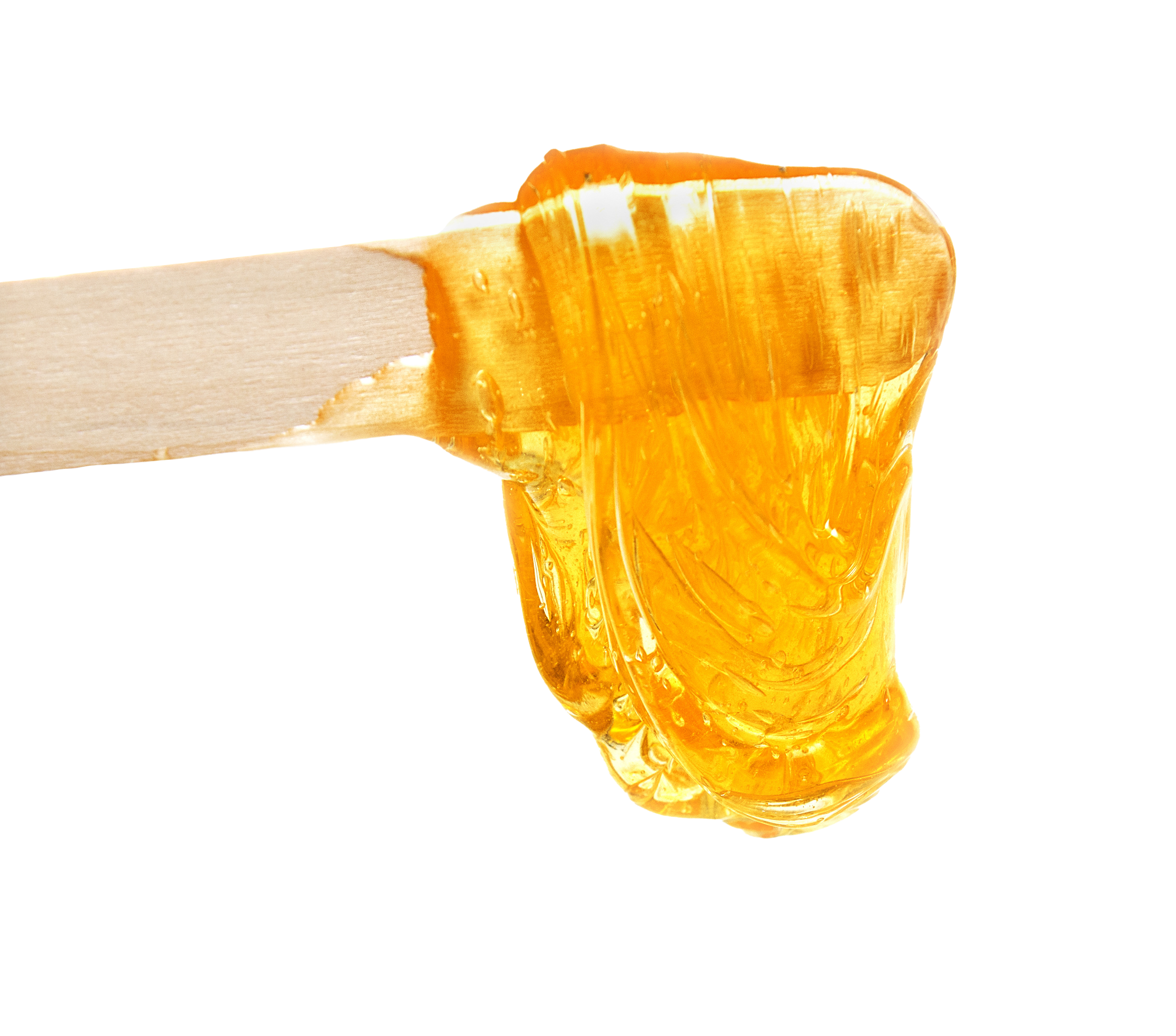 An esthetician stick coated with orange-colored sugar paste.