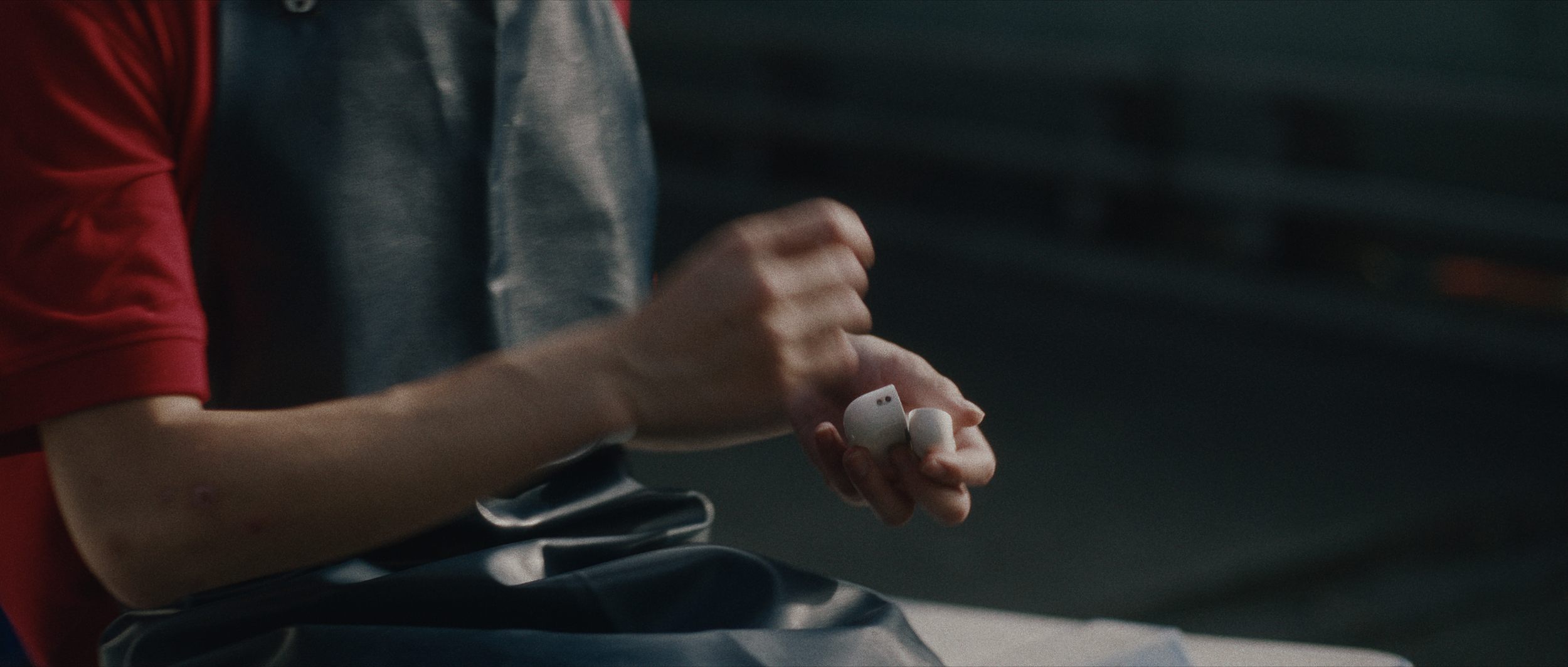 Emery Kaison taking out airpods in I'll Be There For You music video.