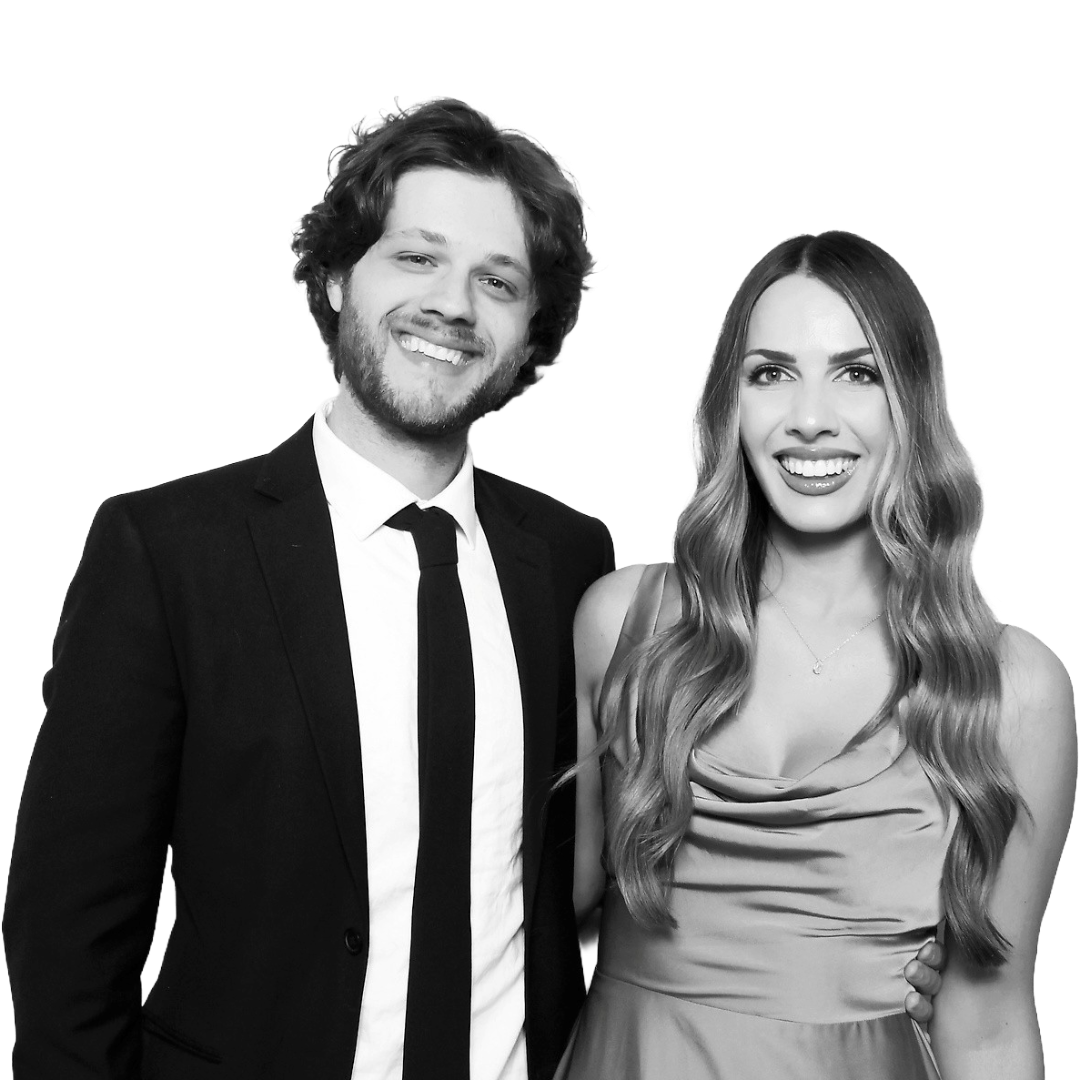 A man and woman dressed in formal attire, smiling for the camera.