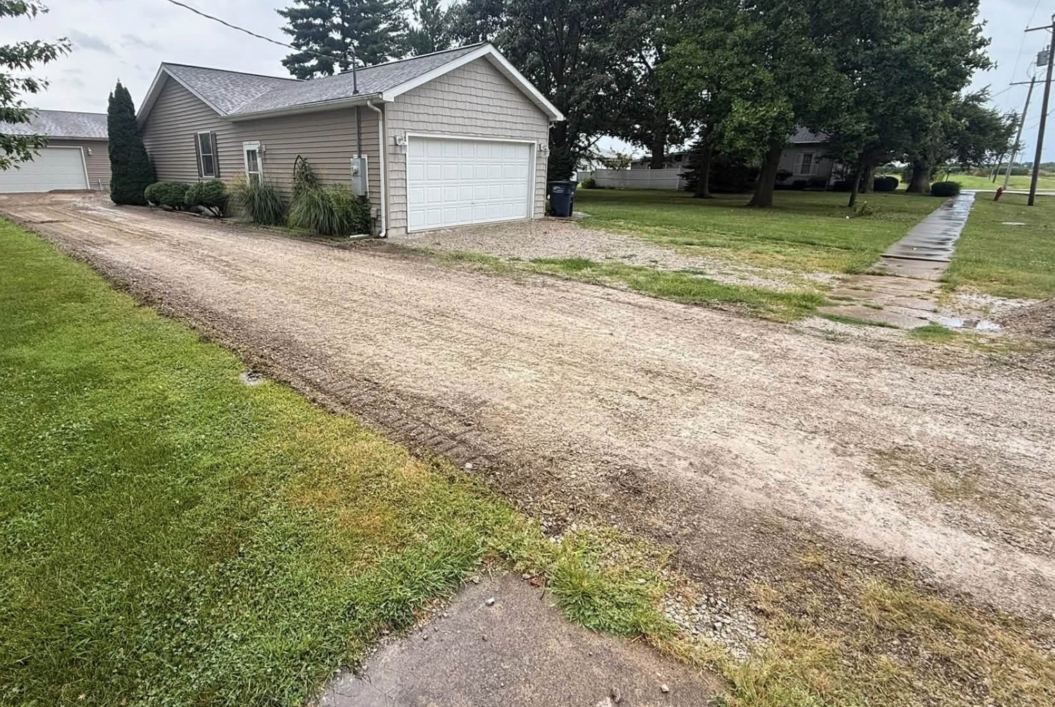 Residential gravel driveway being graded and prepared by 3D Excavating for a new aggregate surface.