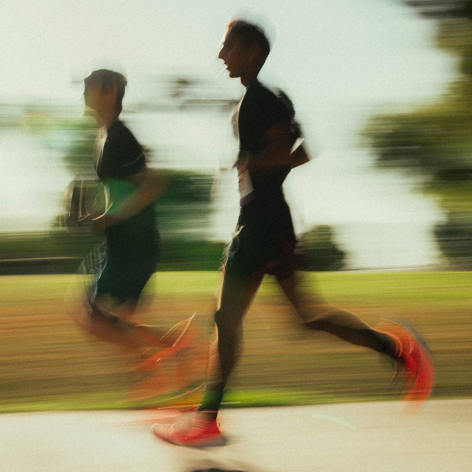 Two Shadow Strike runners sprint toward the next checkpoint with motion blur effects capturing their speed during the Unsanctioned Race in Brea, CA.