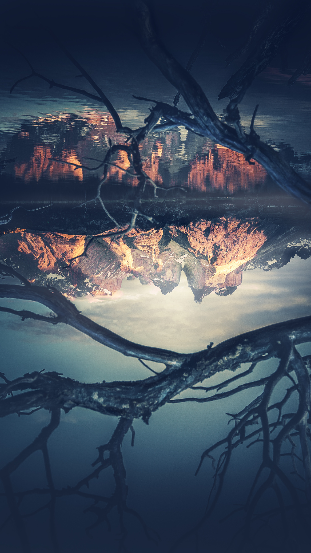 Upside down image of a mountain reflection on a lake, symbolizing the confusion that grief can bring to each person and the perceived or real loss of support.