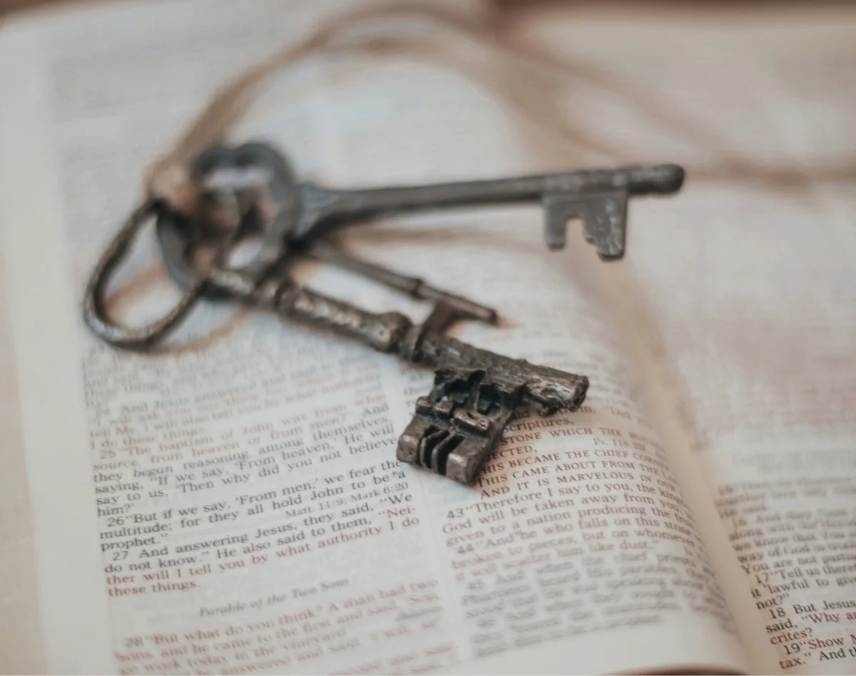 An old key resting on an open Bible — representing forgiveness as God’s master key for healing missionaries