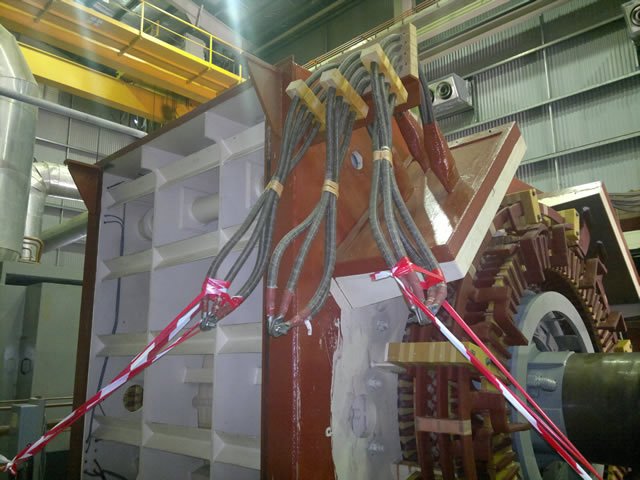 Industrial machinery with cables and mechanical components inside a factory