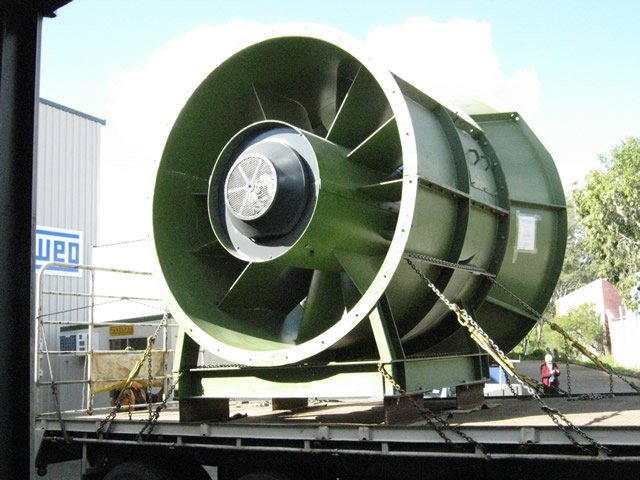 Large industrial fan or ventilation unit on a flatbed truck outdoors.