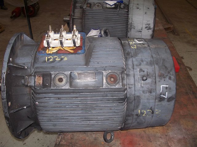 Industrial electric motor with power terminals and labeled markings.