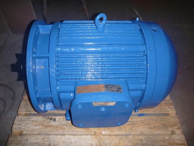 Blue industrial electric motor on a wooden pallet