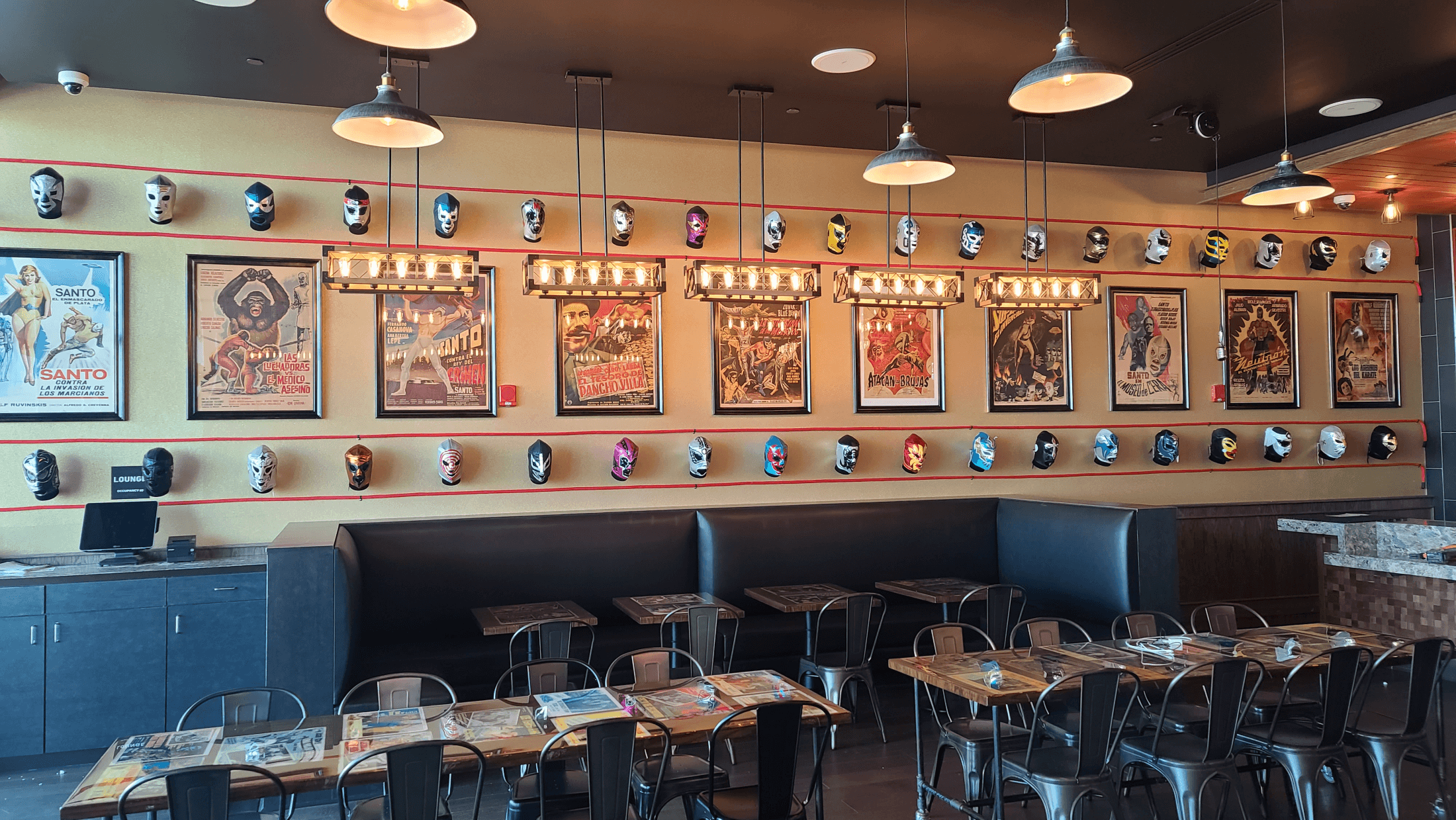 Luchador Mask Wall: A bold, colorful grid of vintage and custom Lucha libre masks, creating a high-energy focal point.