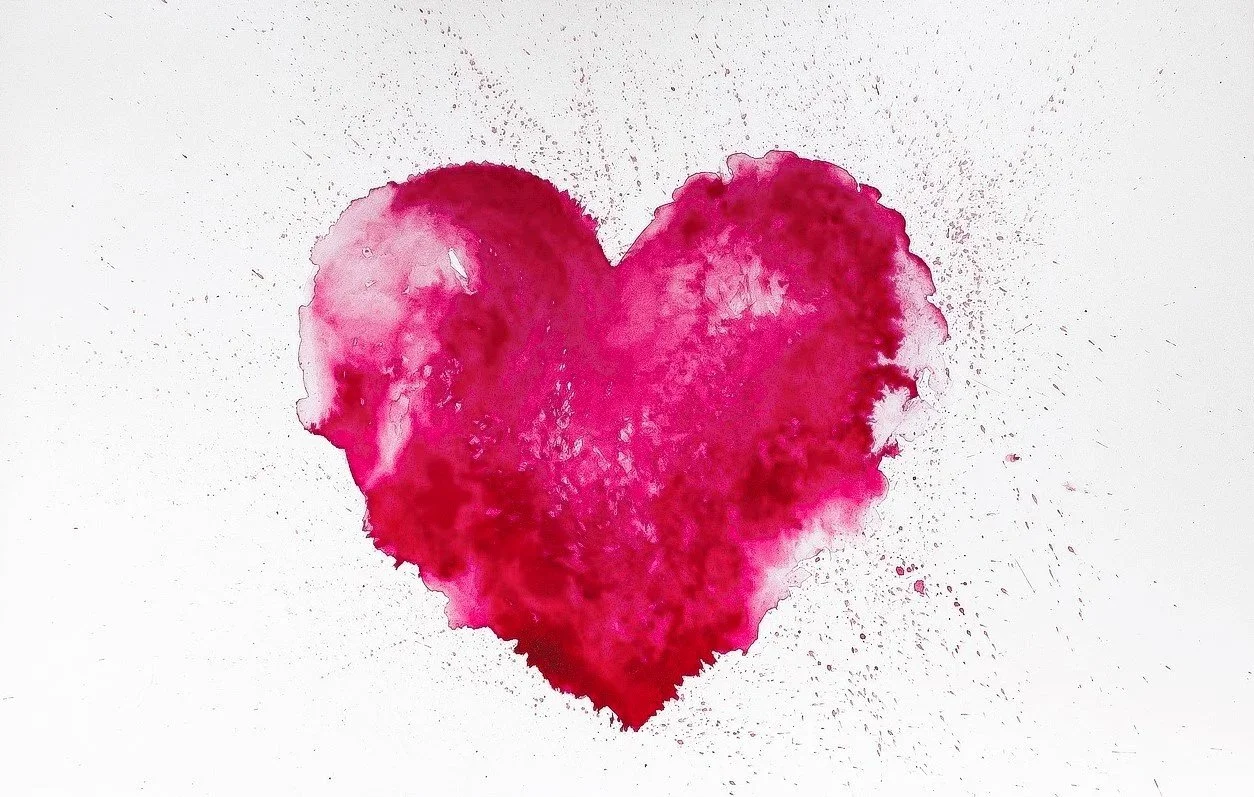 Pink watercolor heart on white background.