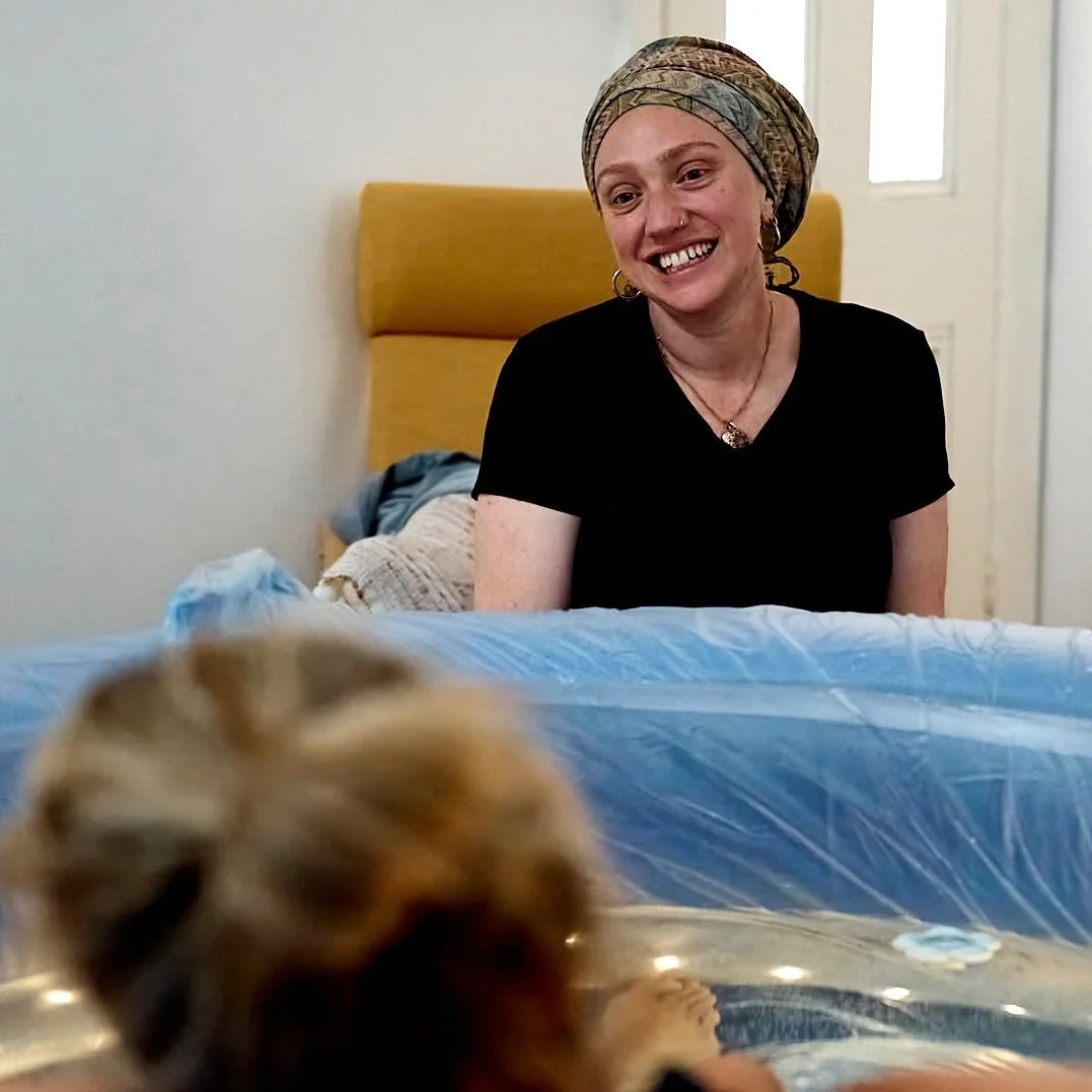 Jennifer Hazi, private midwife, smiling warmly during a home visit in Paddington, Sydney