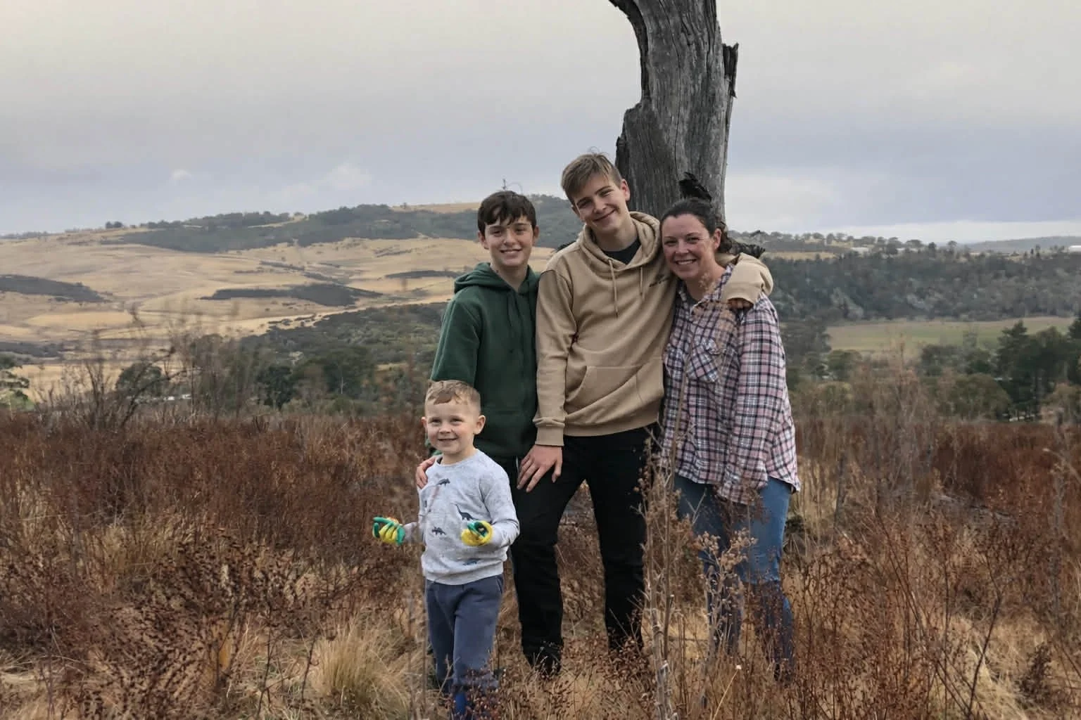 Hayley Simpson, founder of Kora Wellness, with her three boys outdoors in the Australian countryside