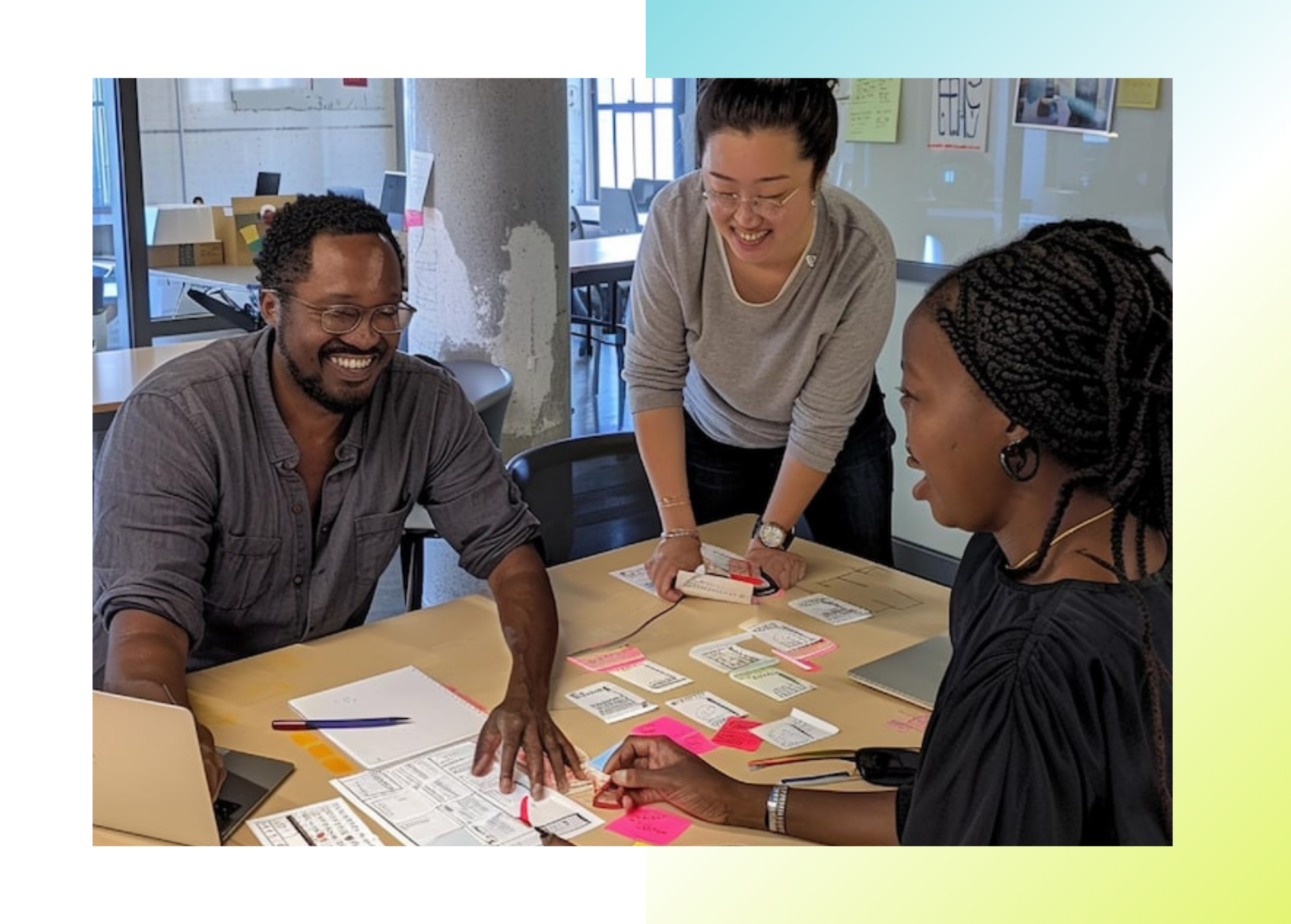 Designer and developer working together at a whiteboard reviewing design sketches