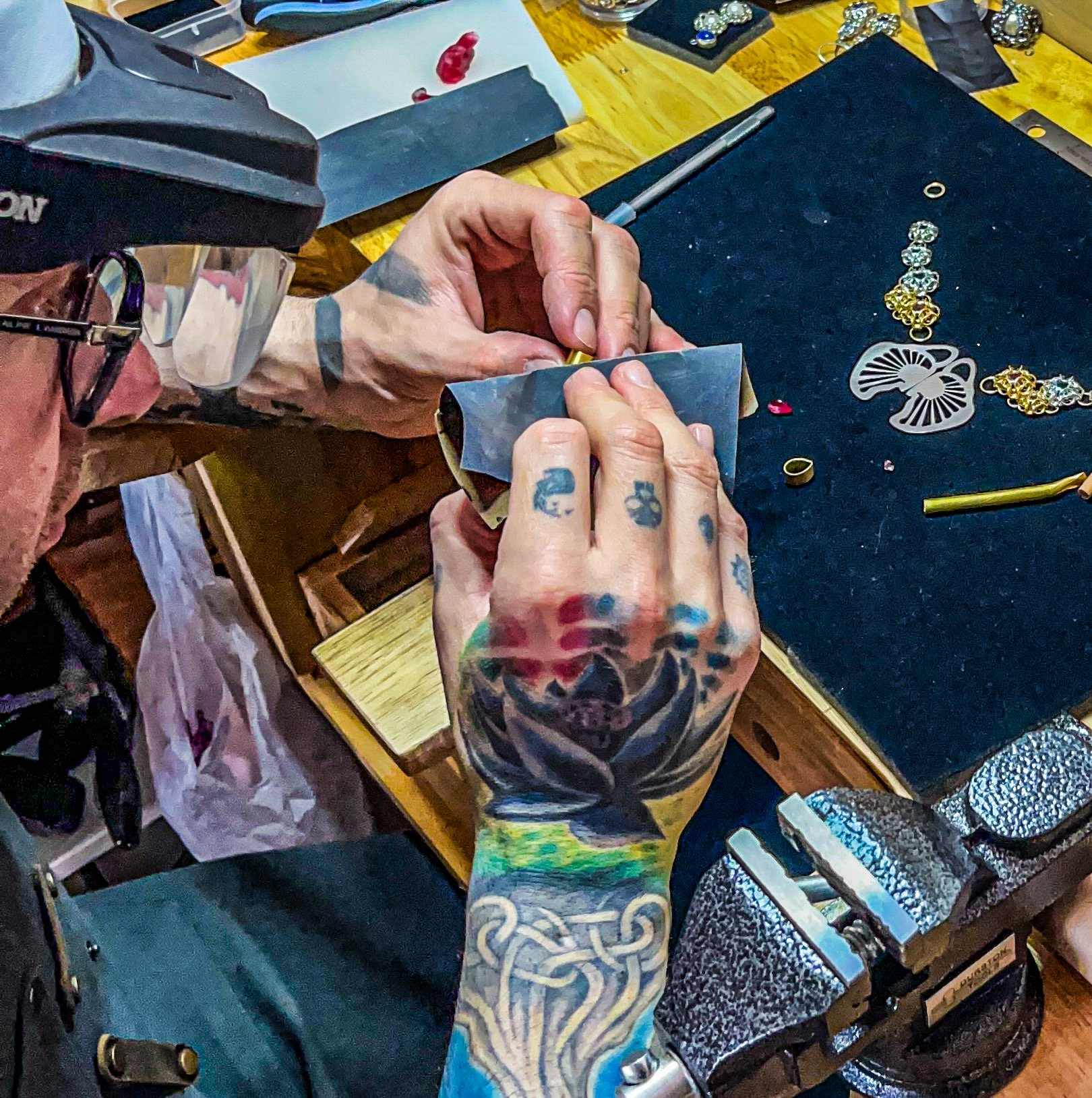 Jae Breslow at the bench, assembling the orchid necklace