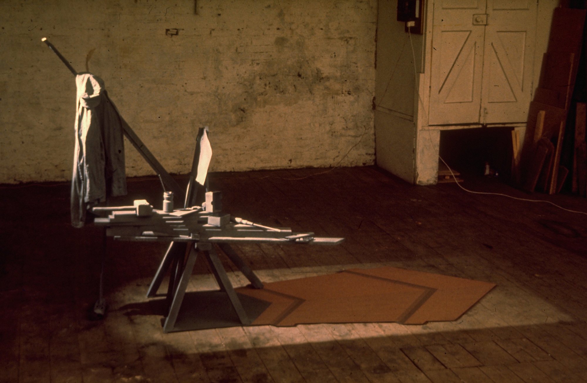 Shadow Crate V. Wood and paint on green baize with framing spotlight. 108 long. 1972.