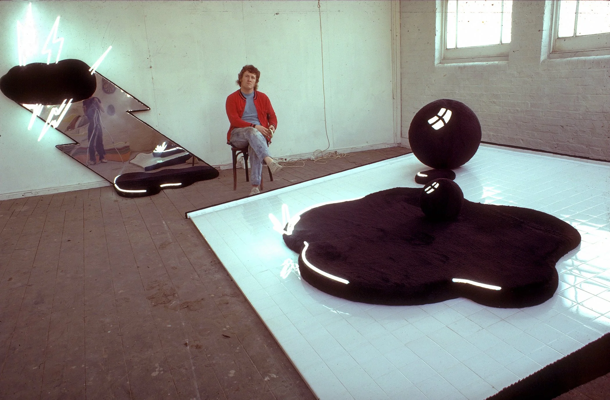 Black Puddles. Resin and fibre glass, foam rubber, black fur fabric, bathroom tiles and neon. 10ft long x 10ft wide. 1970. (Ferens Art Gallery Collection, Hull).