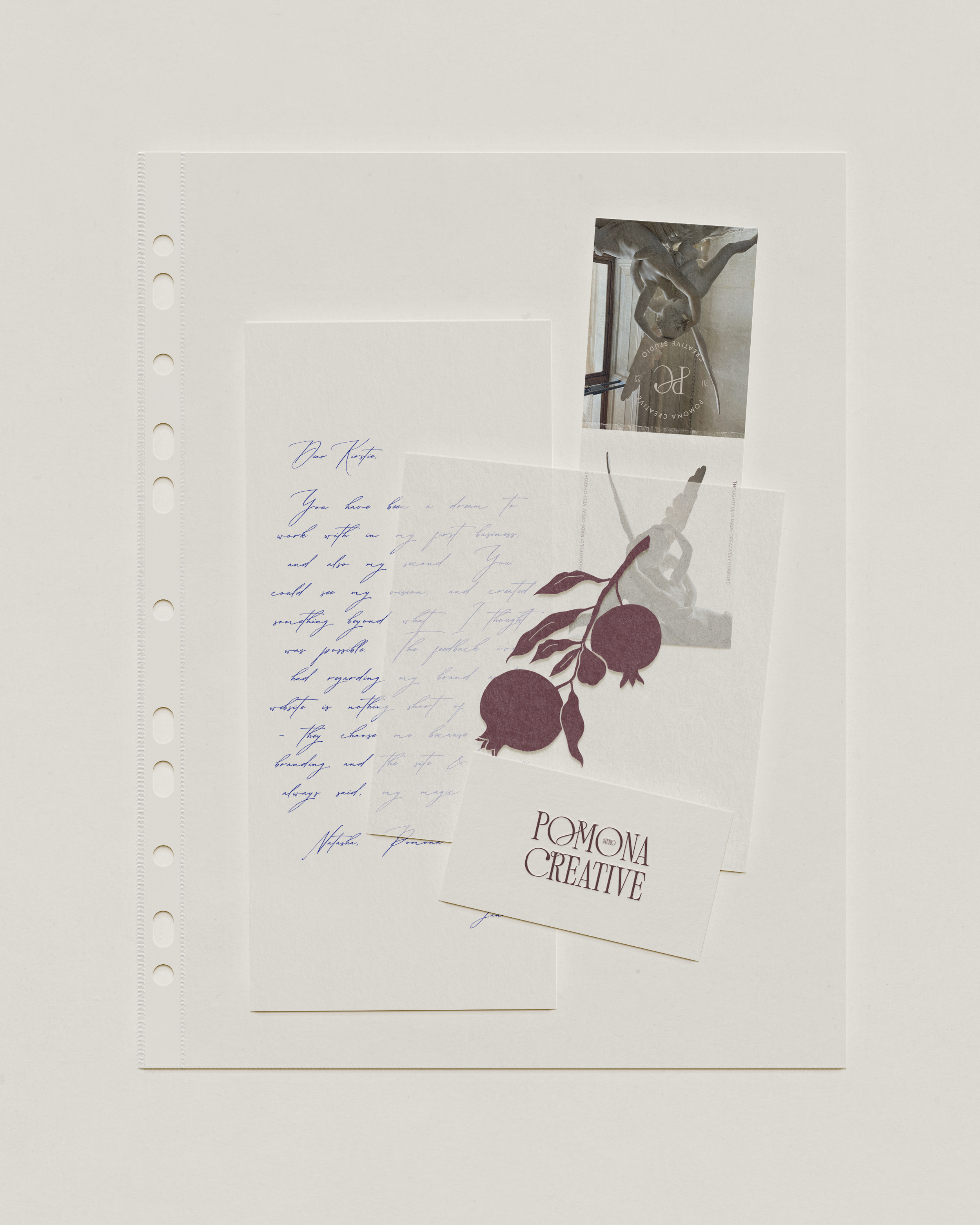 A collection of stationery items including handwritten letter, printed card, photography, and decorative paper on a white background.