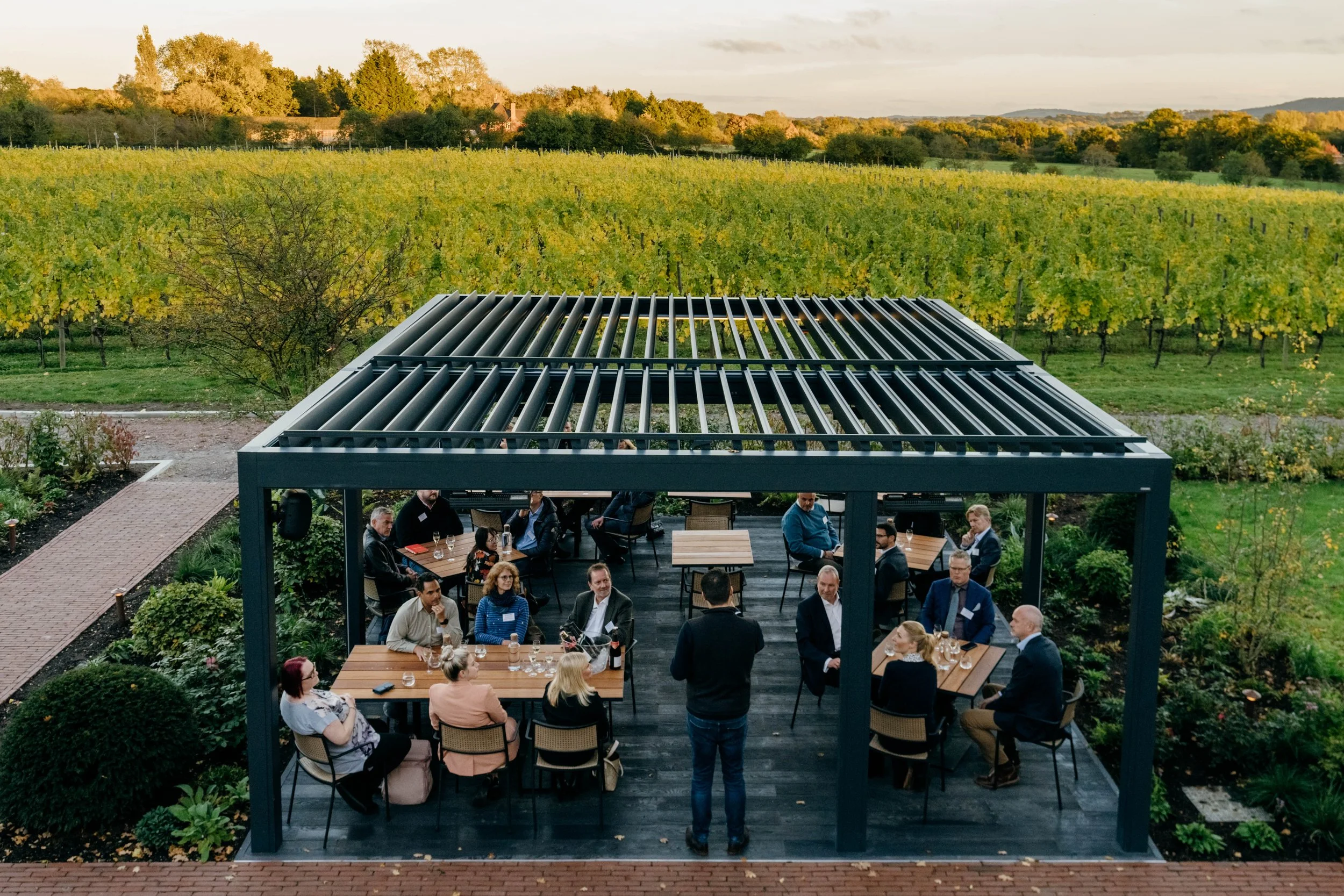 Colleagues attending an offsite meeting with an unique vineyard view in Sussex, England.