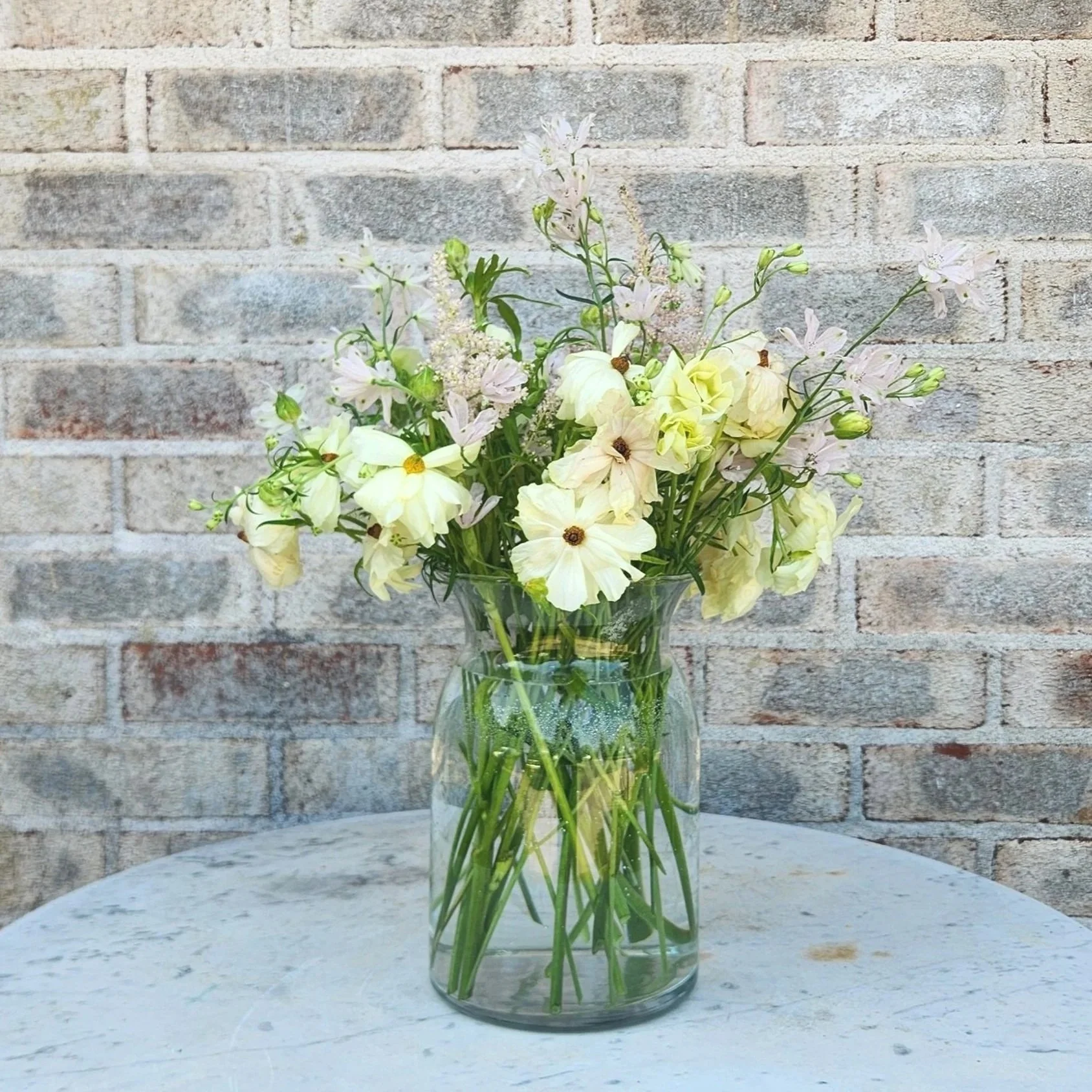 A bespoke, hand-tailored white minimalist flower arrangement by Quogue Flower Shop, perfect for your loved ones or a last-minute meaningful gift.