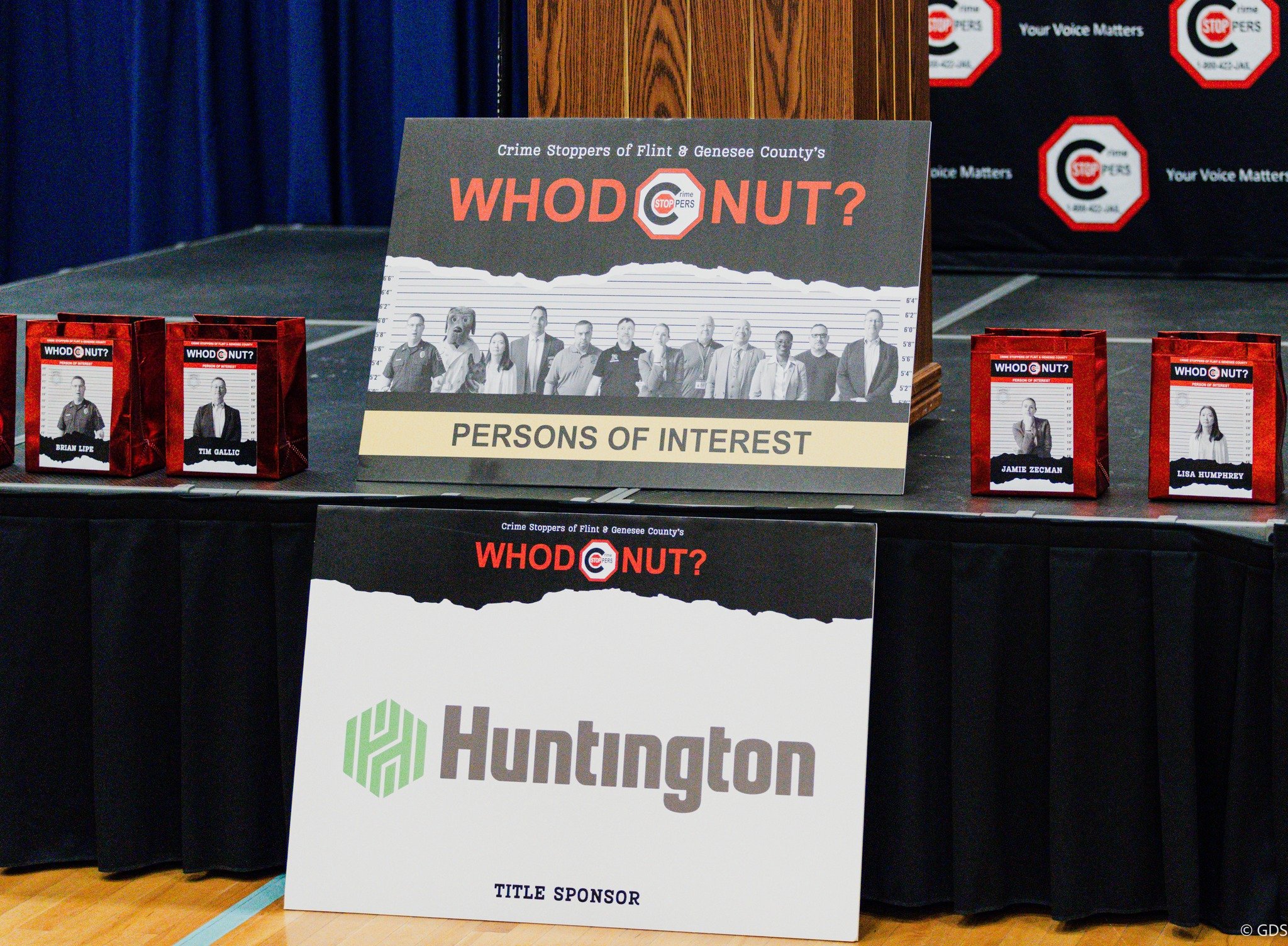 Event signage and individual "Persons of Interest" containers, where guests could submit their best guesses for the suspect!