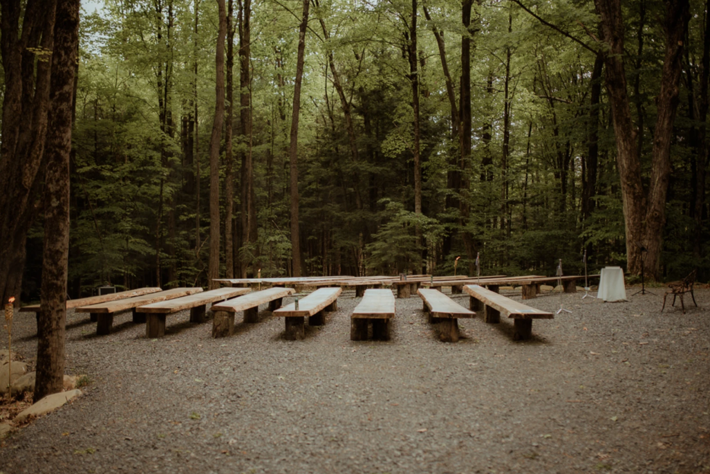 Outdoor forest ceremony setup at Brookledge wedding venue in Upstate New York with chairs set among trees