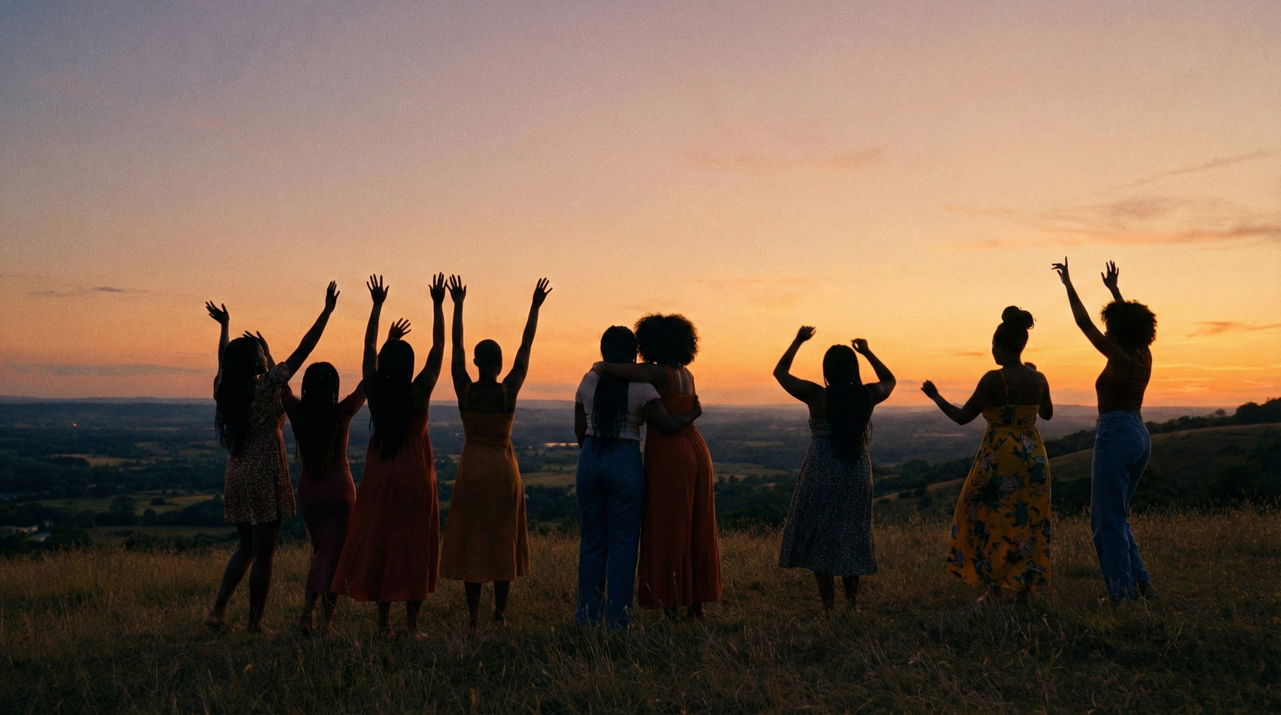 Silhouettes of women with hands raised against a sunset, representing the legacy of collective resilience, spiritual connection, and the "Lift Every Voice and Sing" theme of the blog post.