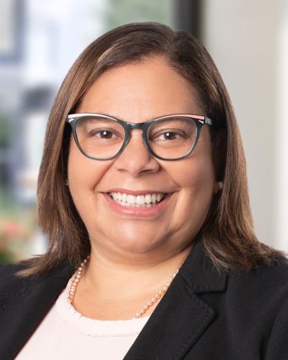 smiling woman with glasses with medium length hair