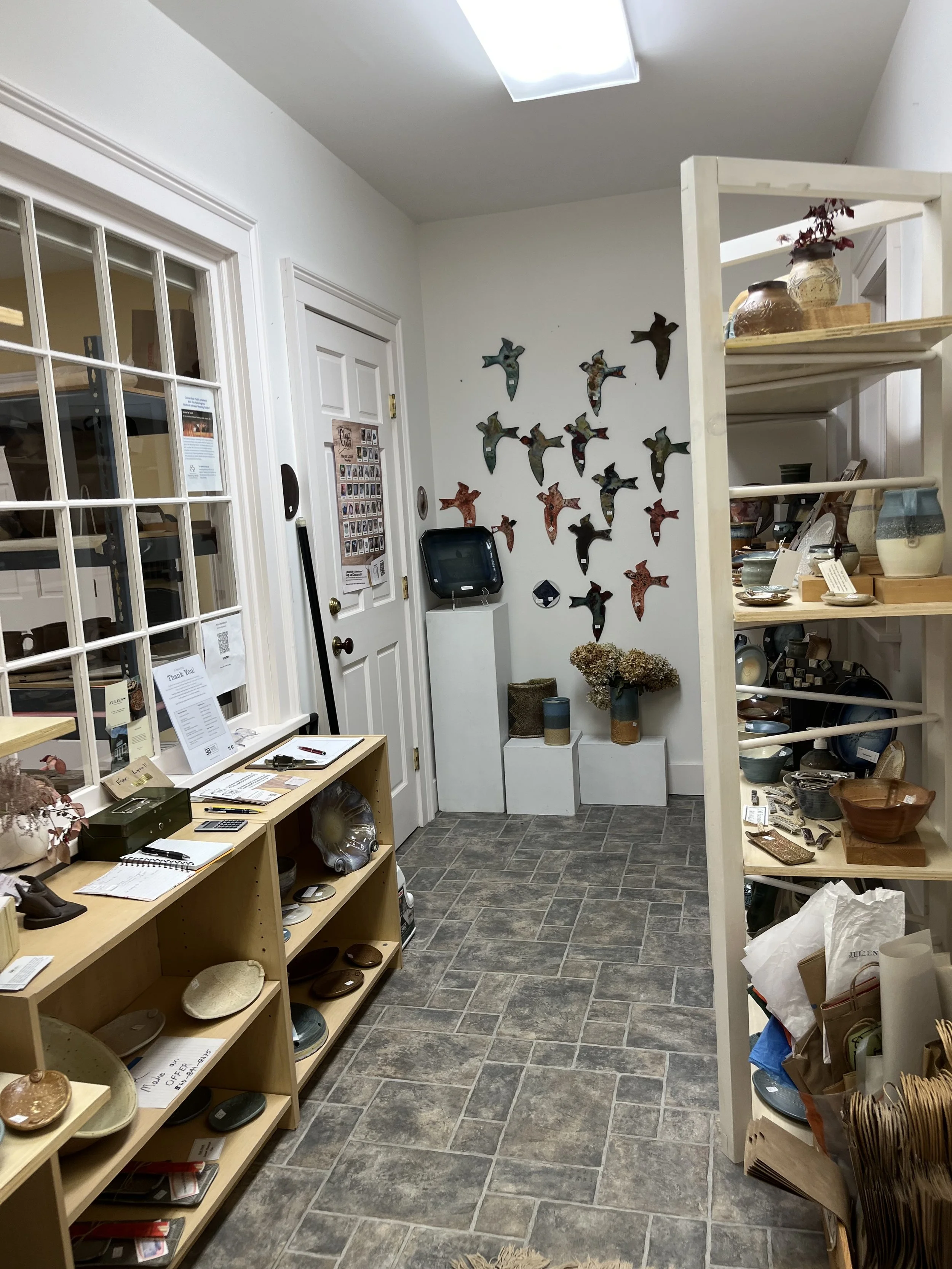 A rectangular ceramic dish with blue and beige glaze, featuring intricate floral patterns on the base and decorative edges.