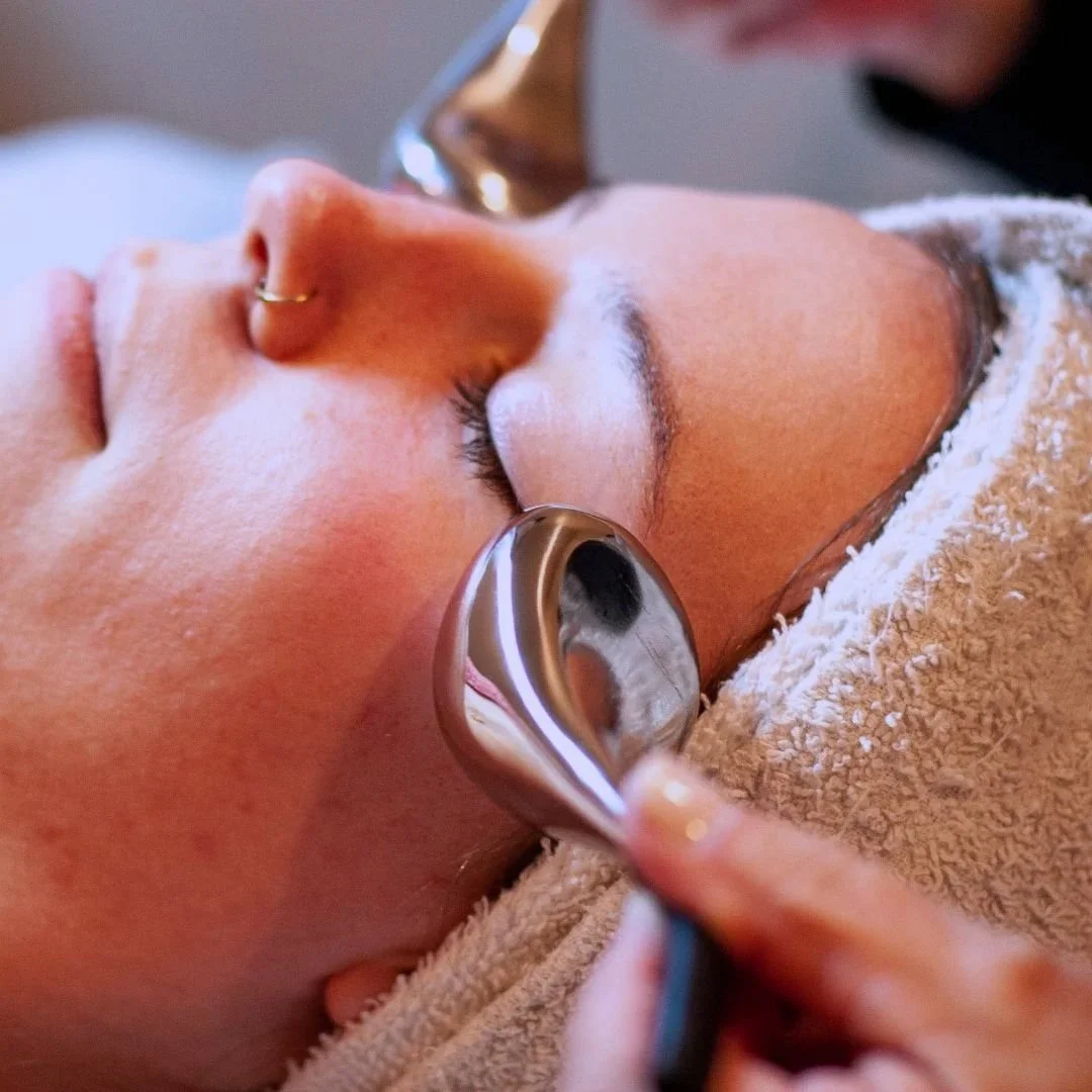 Person receiving facial treatment with cooling globes, having a relaxing session and sinking into the moment.