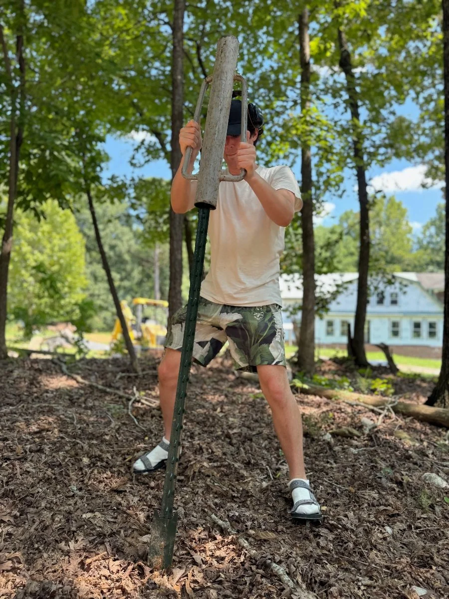 Colten Jackson learns how to install basic fencing during a workshop at Deep River Folk School