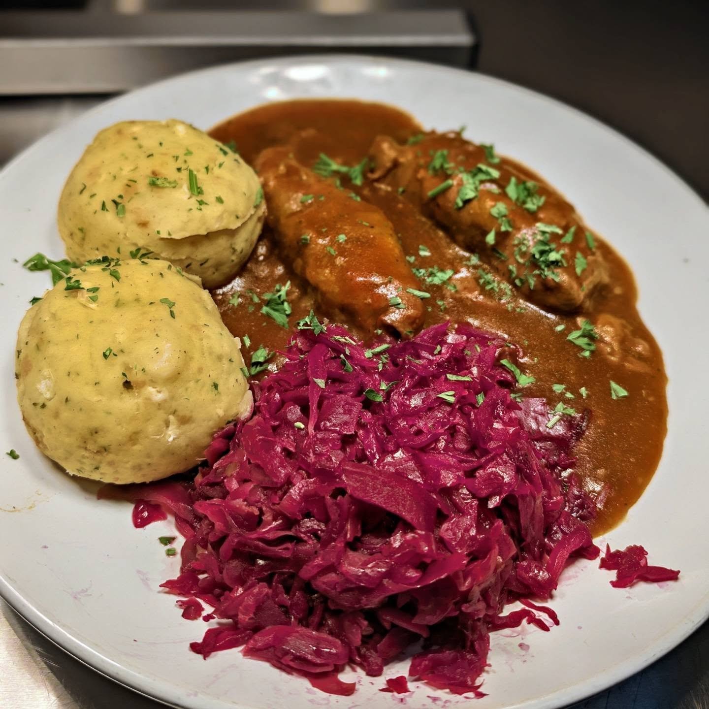 Meet the Rouladen. Two classic German Rouladen, slow-braised to perfection, paired with two pillowy homemade Semmelkn&ouml;del and our fresh-made Rotkraut. Every element crafted from scratch &mdash; right down to the rich, savory sauce made from the 