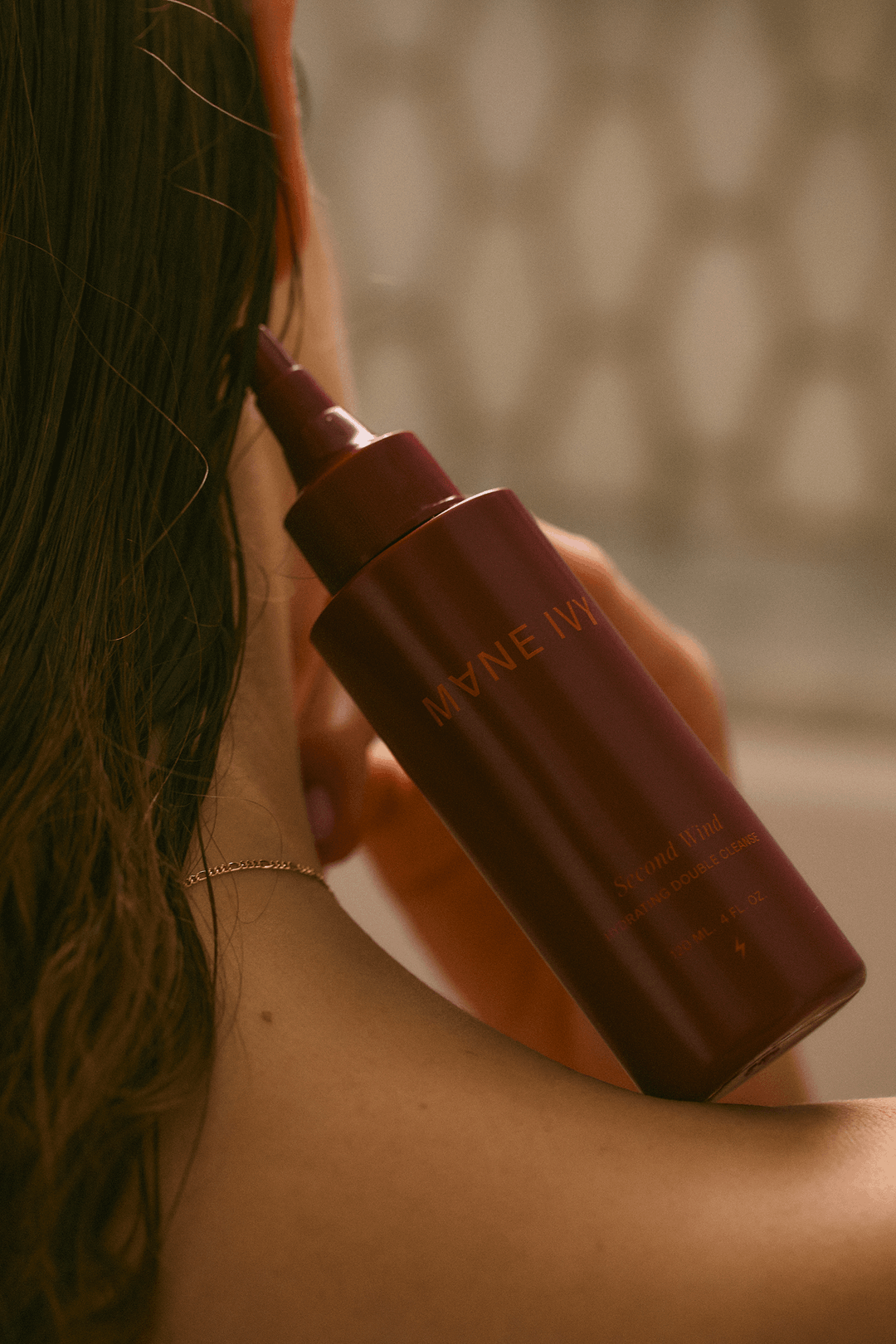 a woman holding a scalp cleanser for hair health
