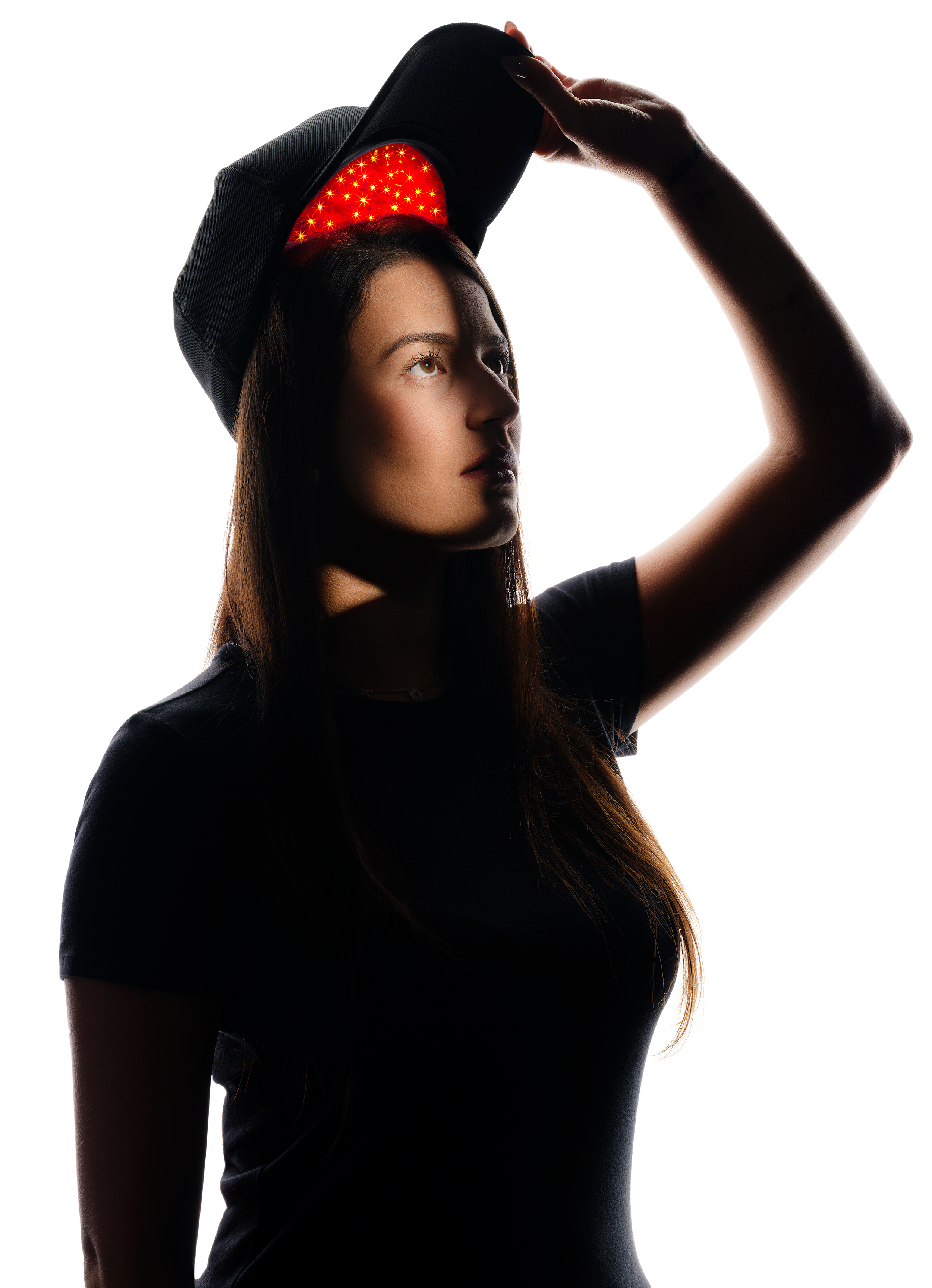 a woman with a medical grade laser therapy cap on her head
