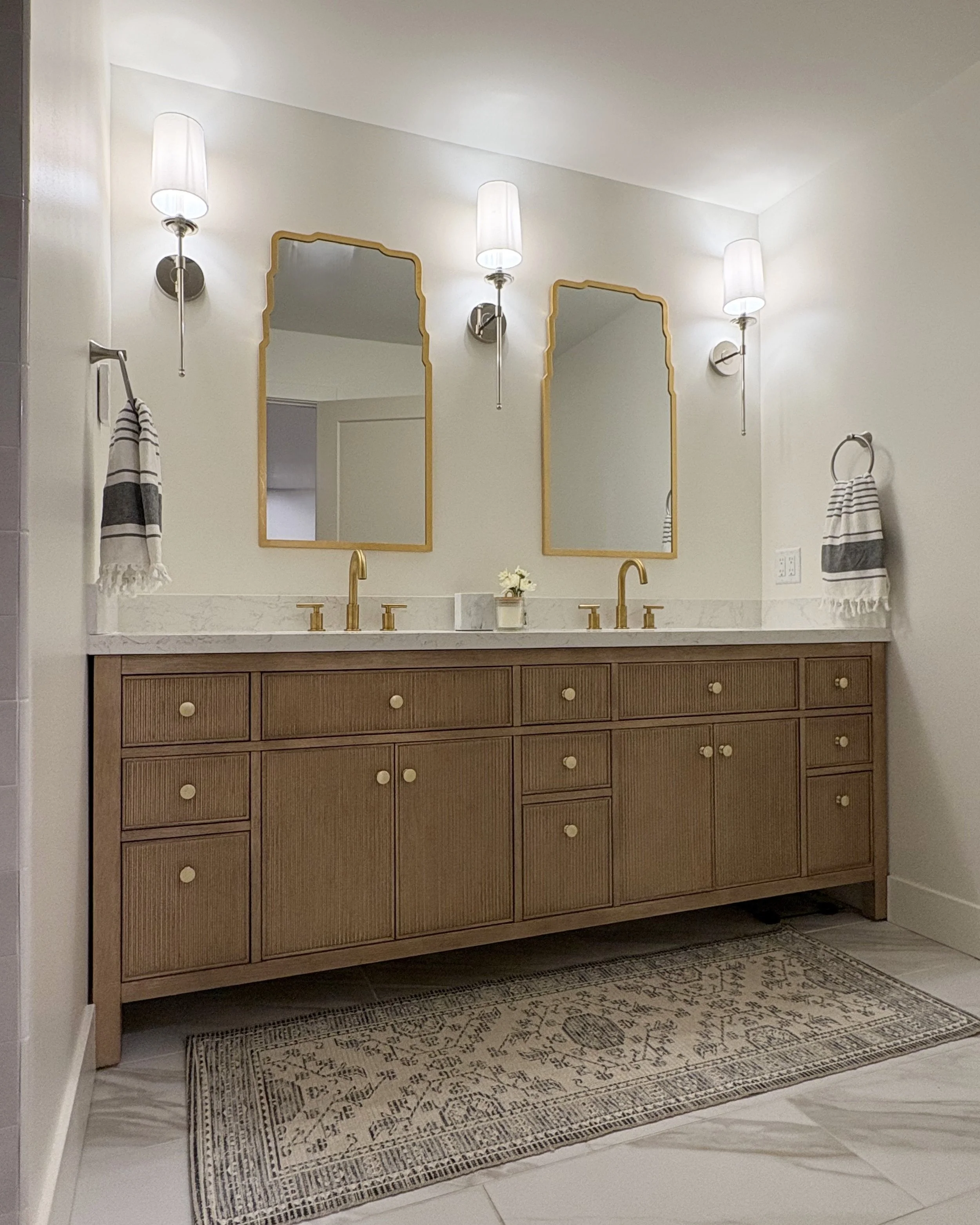 It's all about the details in the Master Bathroom at the #RanchRemix. Some details you can appreciate visually like the fluted wood accents on the vanity, the interesting lines of the mirrors, and the handcrafted look of the shower tiles. Other detai