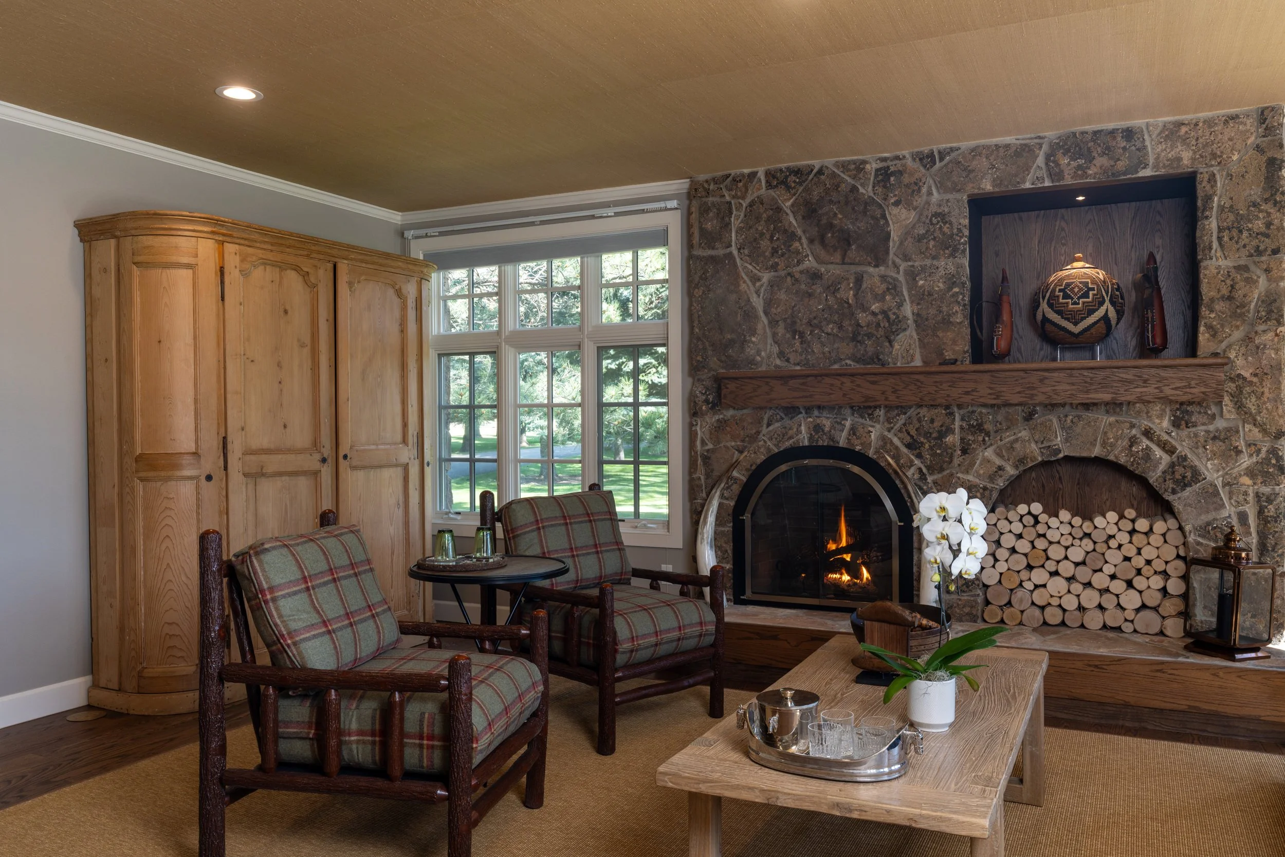 Living room with stone fireplace at Rivenrock Lodge
