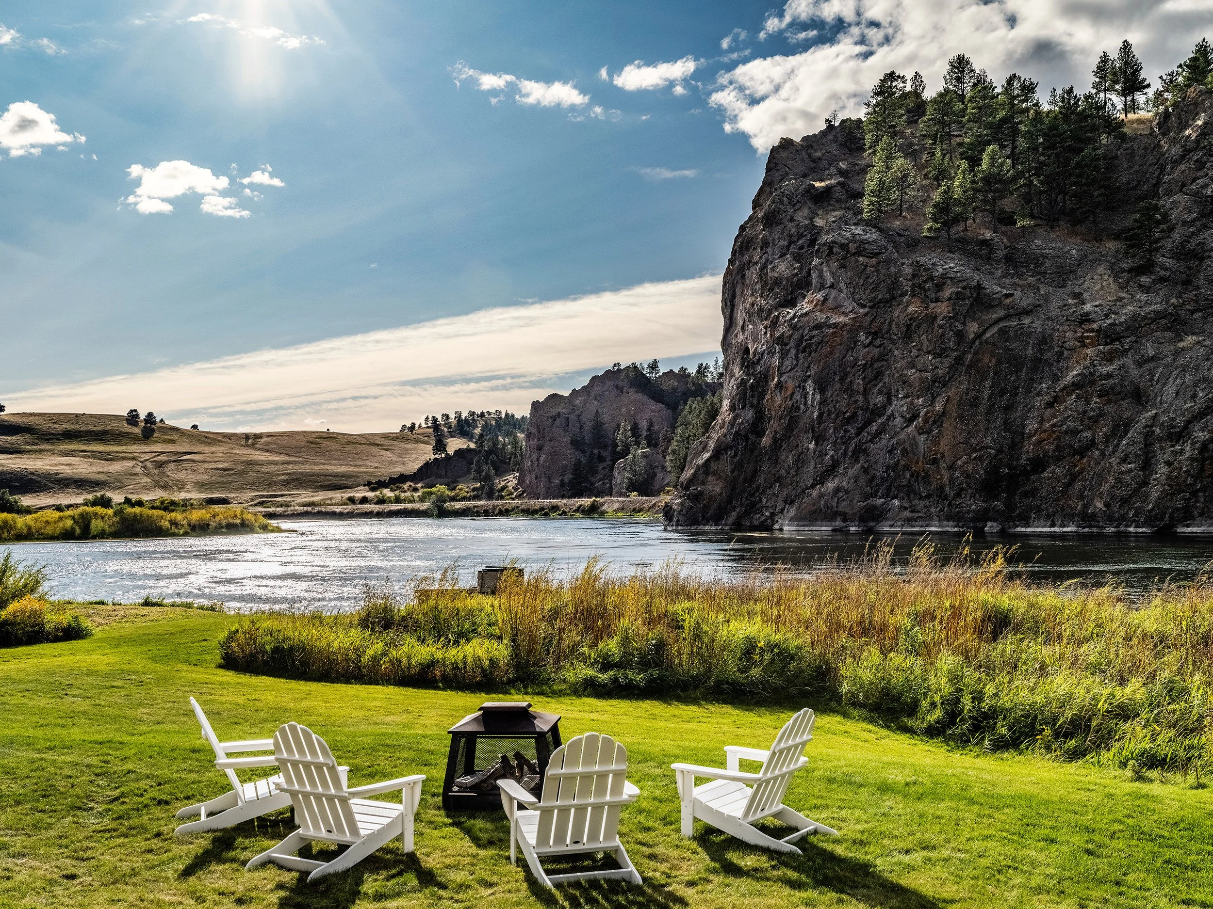 Adirondack chairs facing the river at Rivenrock