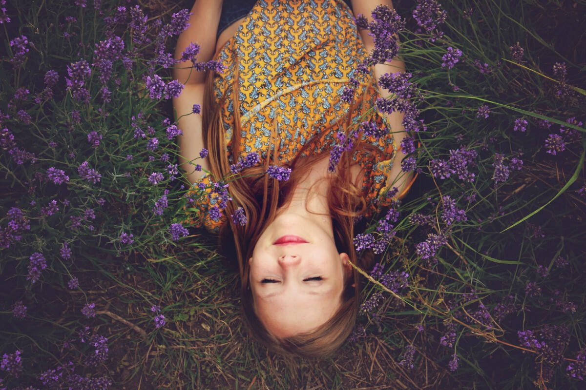 Woman laying in field of lavendar