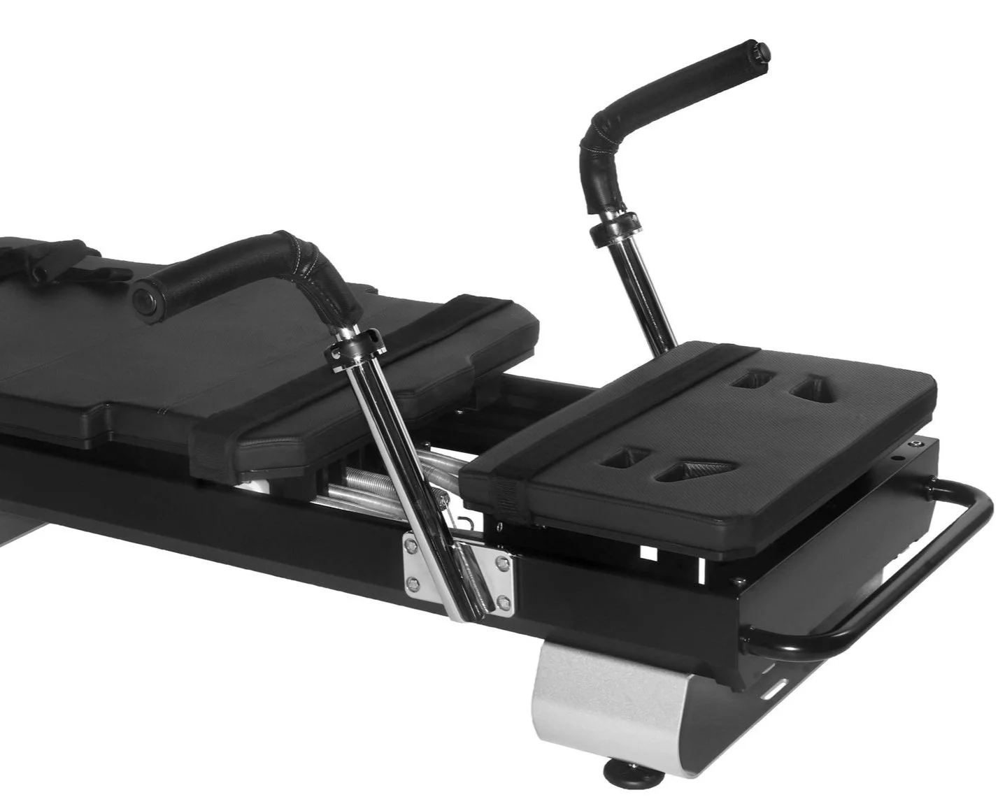 Close-up of a black Pilates reformer machine with handlebars and adjustable padded seat.