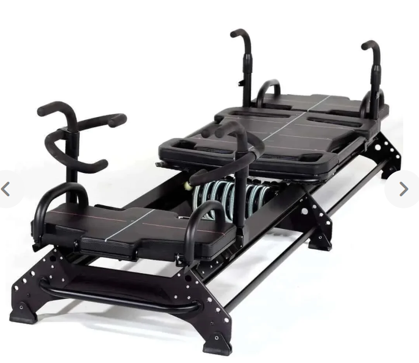 Pilates reformer machine with black padding and adjustable bars on a white background.