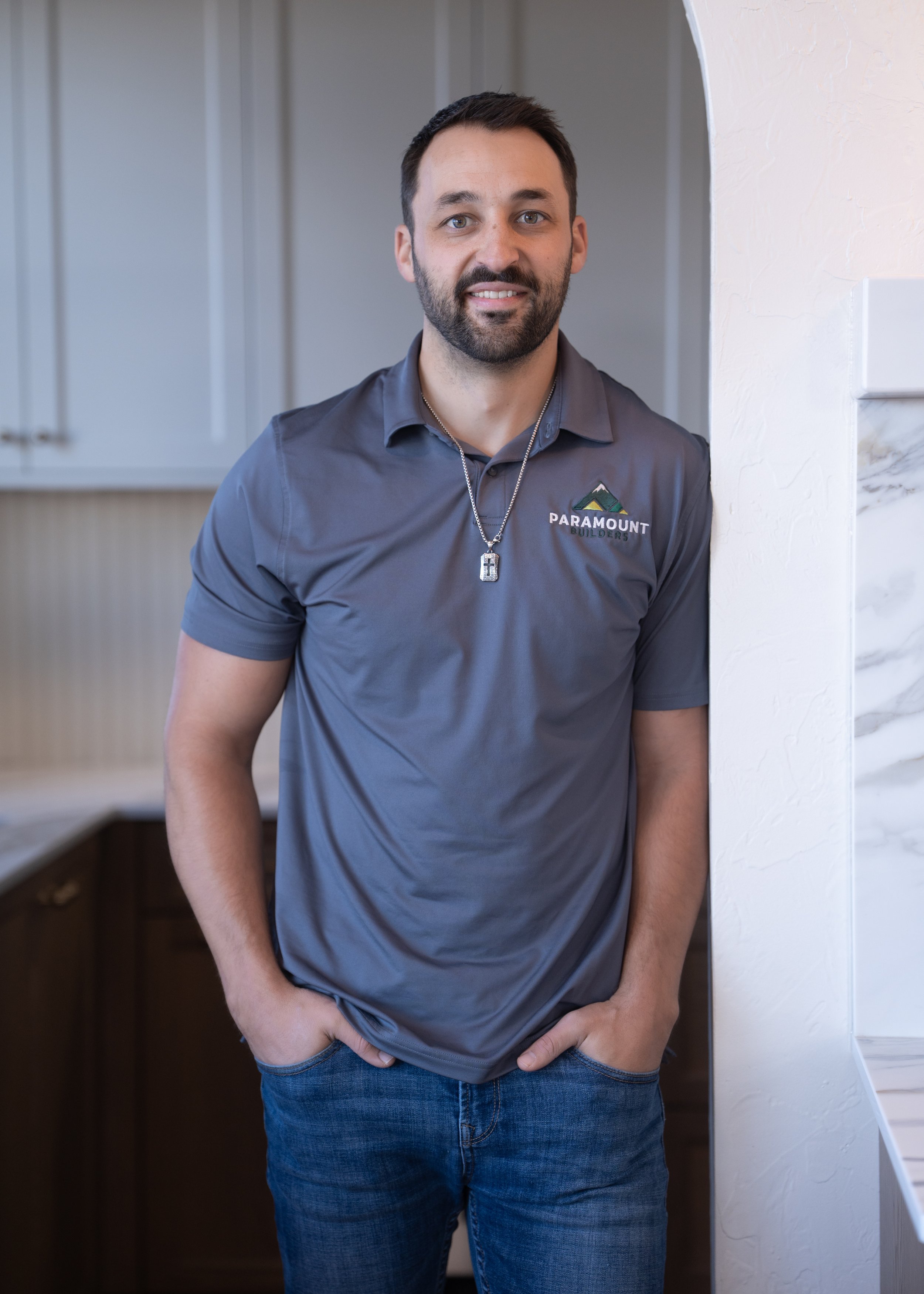 Man wearing black shirt with "Paramount Builders, Inc." logo.