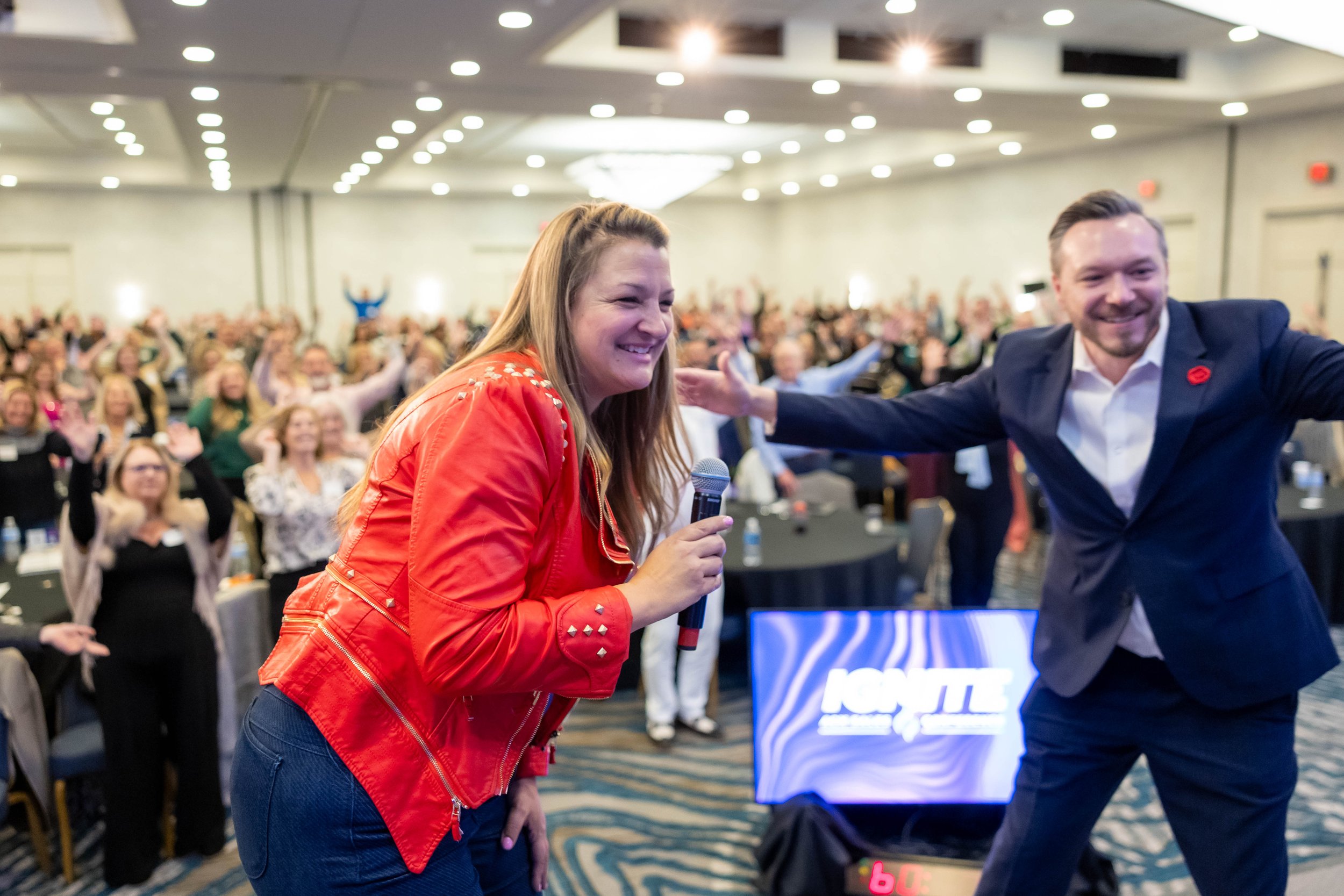 Caryn Grafton presenting on stage at a professional real estate and mortgage sales leadership conference.