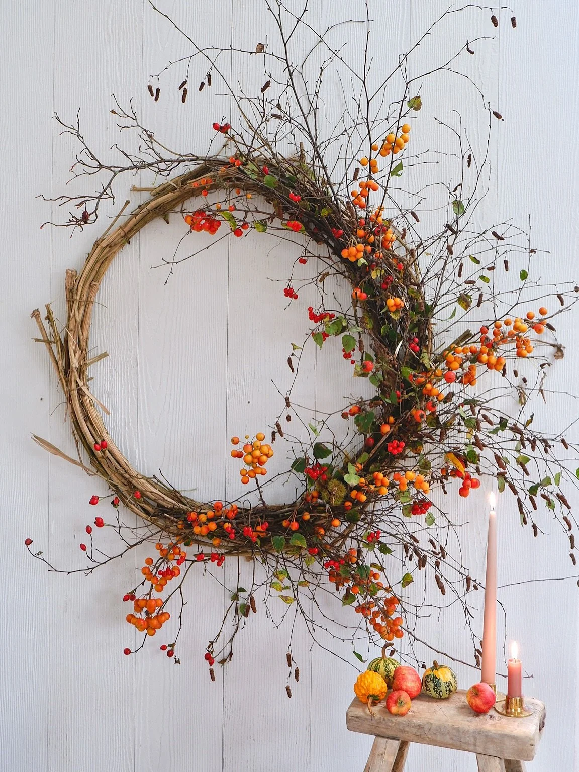Easing myself into wreath season with this autumnal number. The base is wisteria vine and I&rsquo;ve decorated it with rosehips, crab apples and catkins. Our festive wreath classes with @water.lane are booking now.  Link in bio for all the details 

