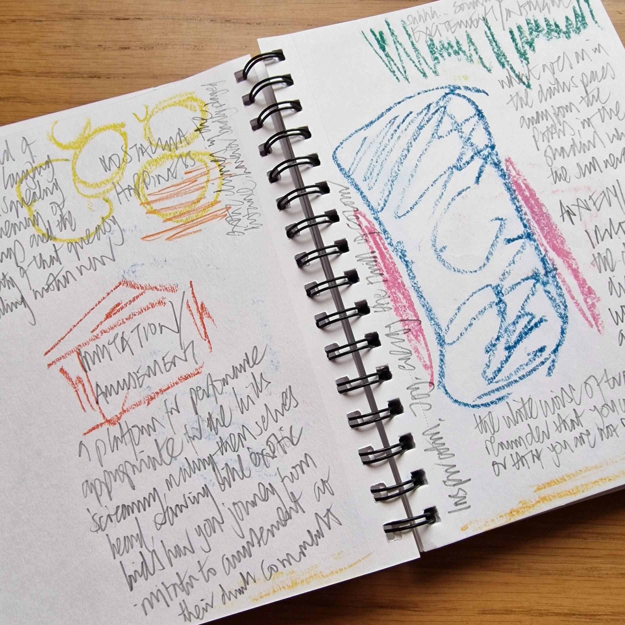 Open sketchbook with colorful crayon illustrations of a sun, a cozy house, and a hot beverage, alongside handwritten notes and ideas.