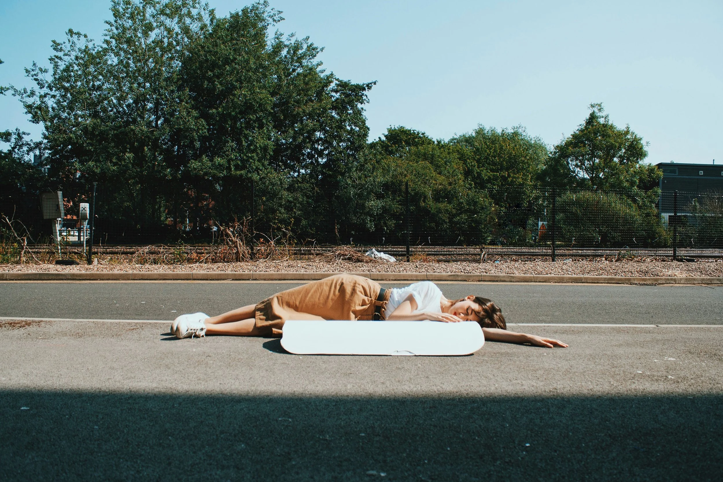 The artist lay next to a representation of a police riot shield made from plaster as part of a performance.