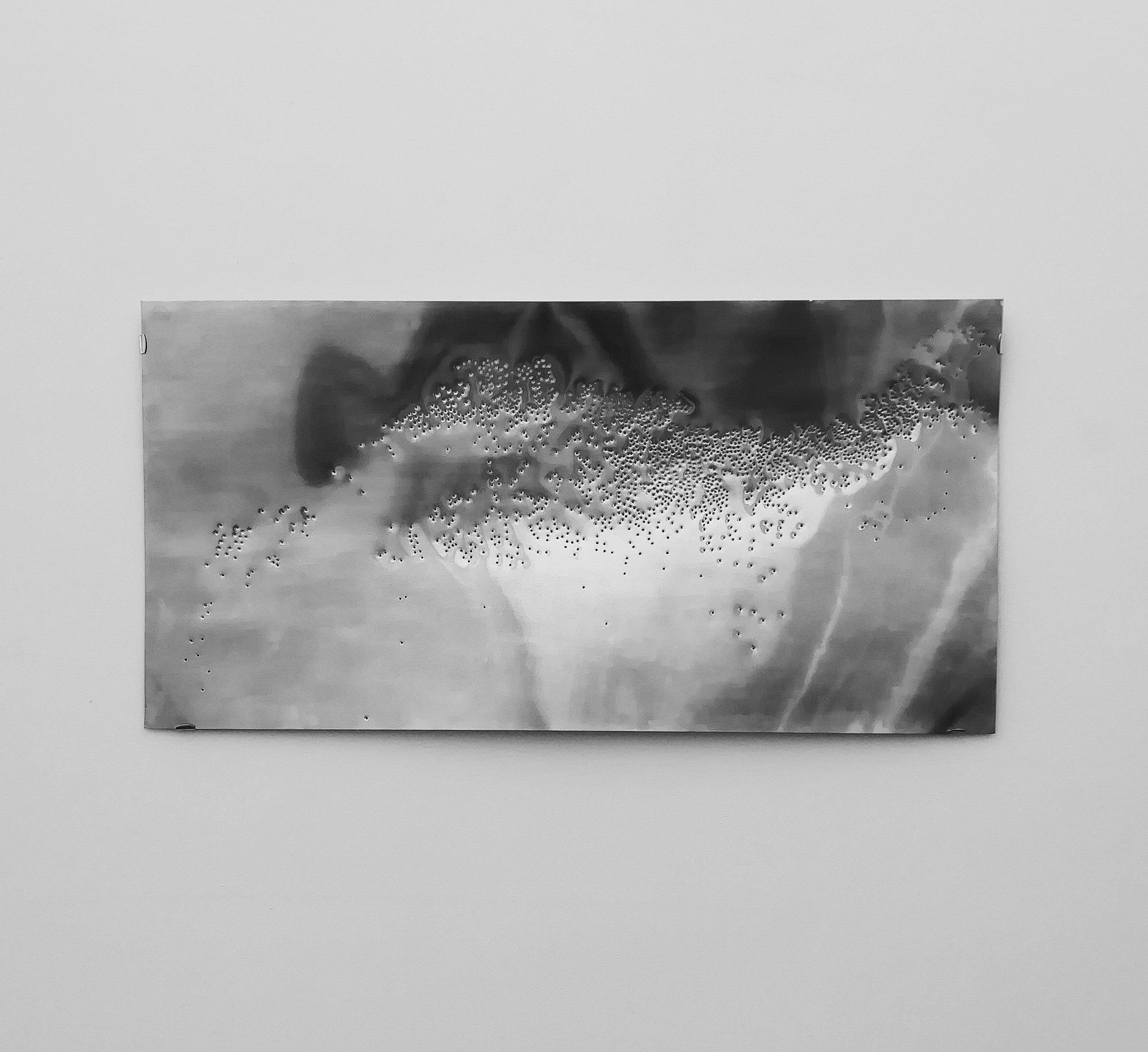 Sheet of aluminium punctured with 2366 holes, each hole representing a drilling site in the Gulf of Mexico. A representation of the Anthropocene.