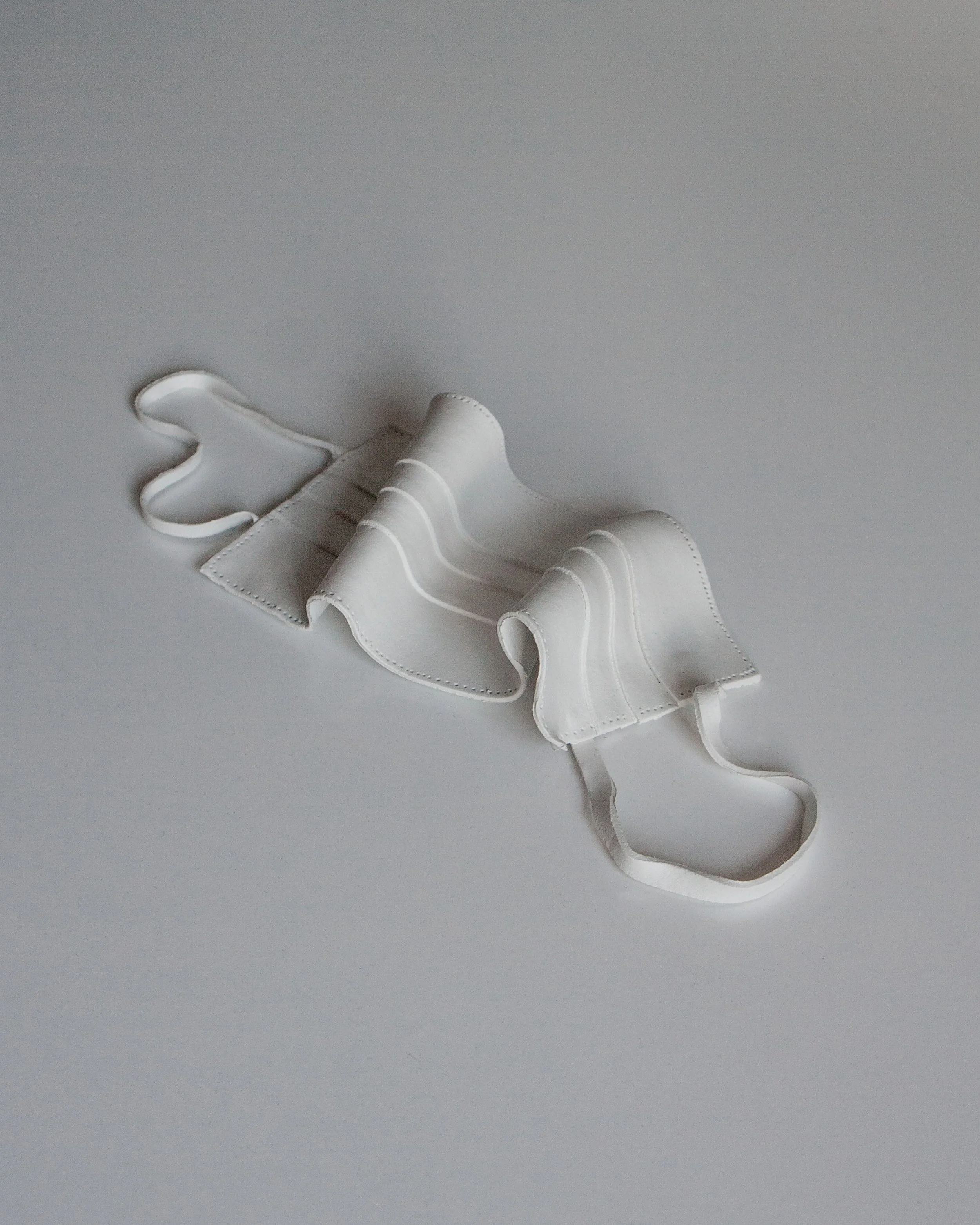 A face mask commonly worn during the covid 19 pandemic, created out of clay as a symbol of resistance and uprising.