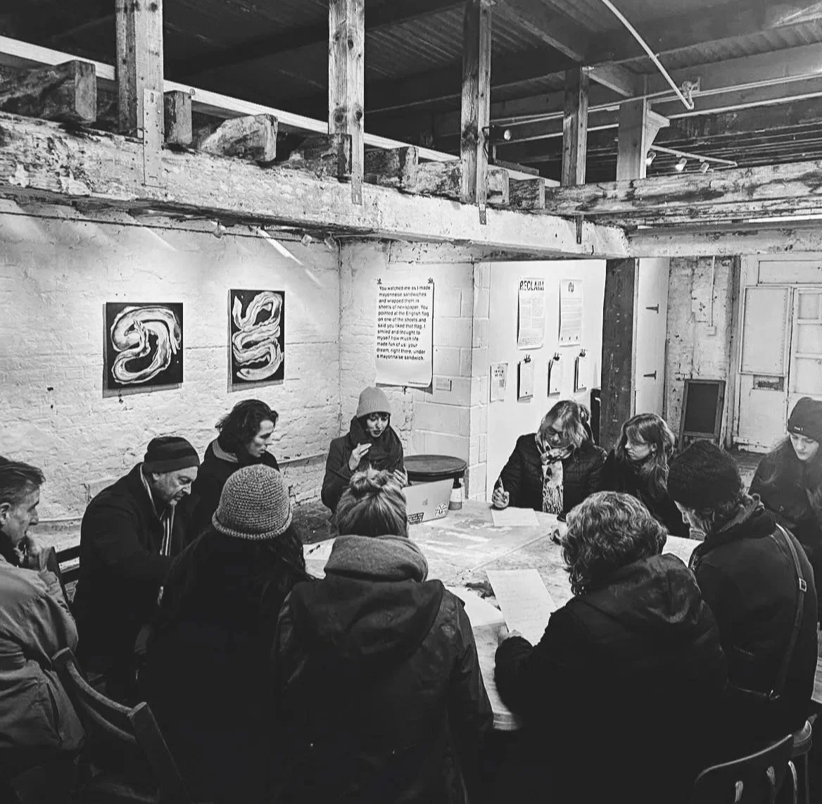 A group of people sitting around a table taking part in a workshop facilitated by Georgia Preece.