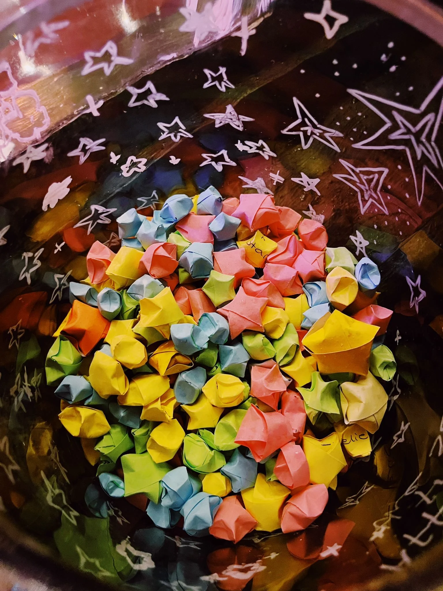 Colorful paper stars created by The Hairy Violets creative writing workshop group, inside a glass jar, presented as part of an event in Lincoln.