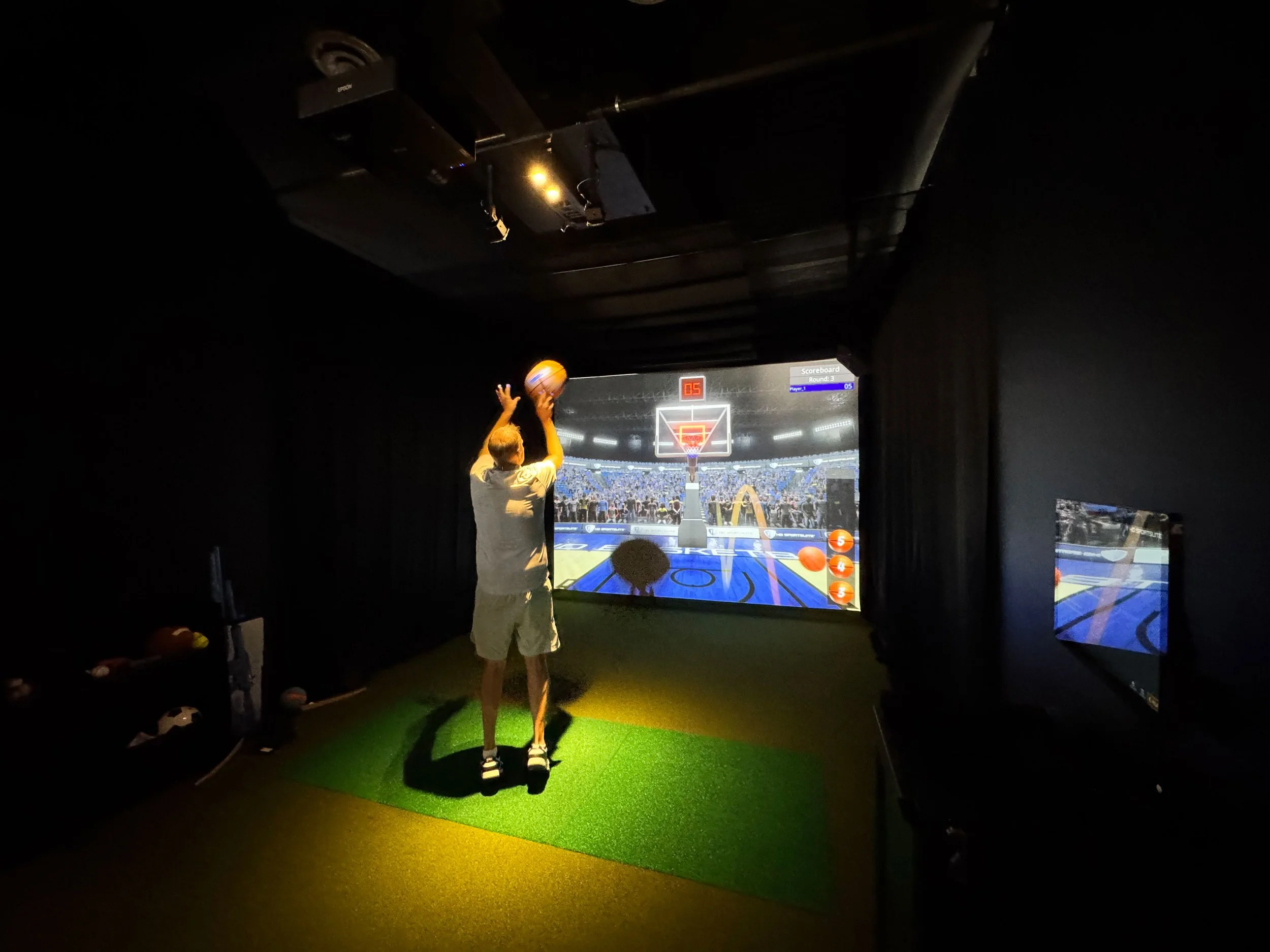 Child playing basketball in an indoor basketball arcade game